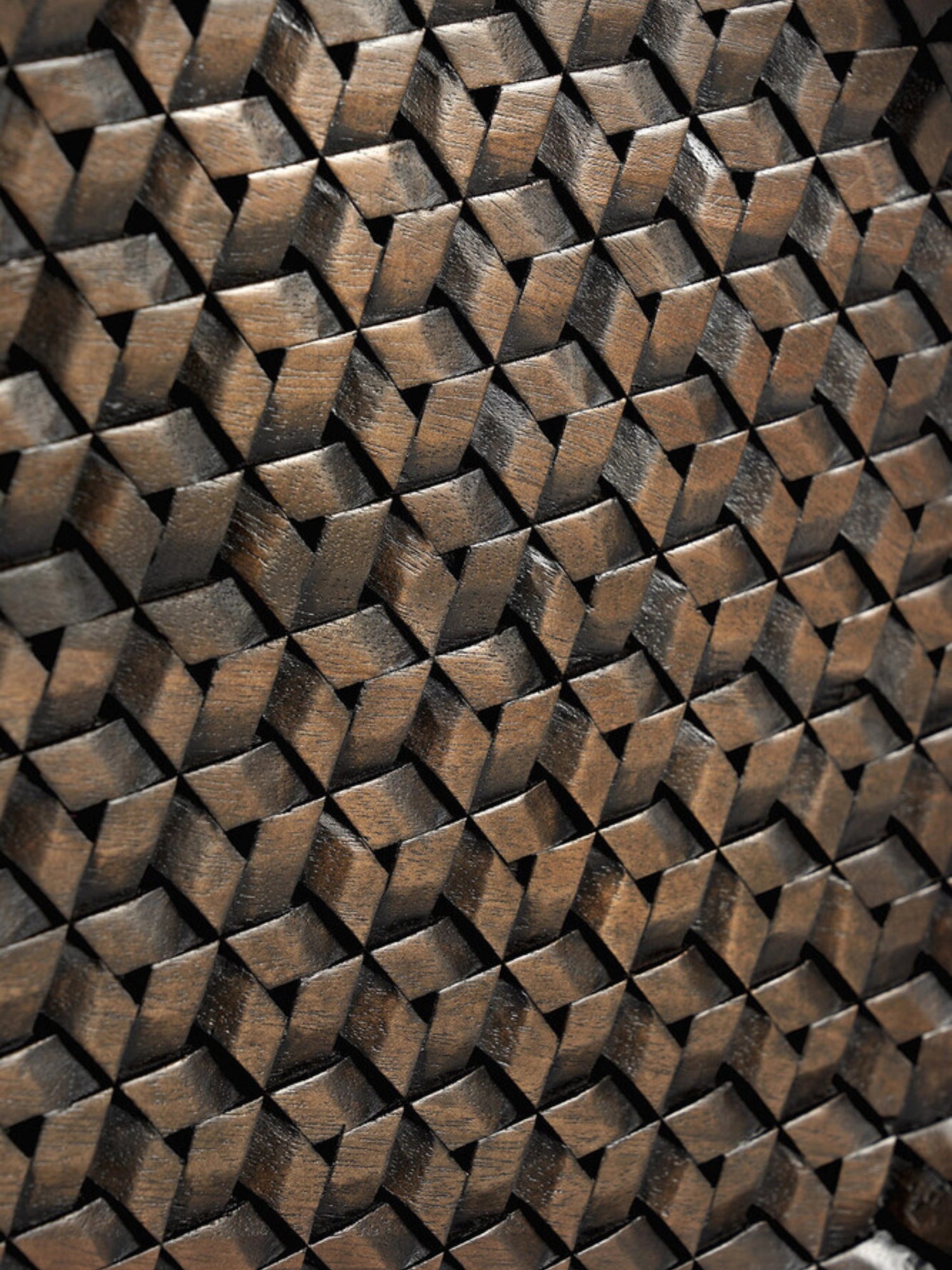 Ethnicraft Tampa Boards Set, a close-up detail of the rich dark brown wooden surface, showcasing the intricate, three-dimensional geometric woven pattern with varying shades and textures.
