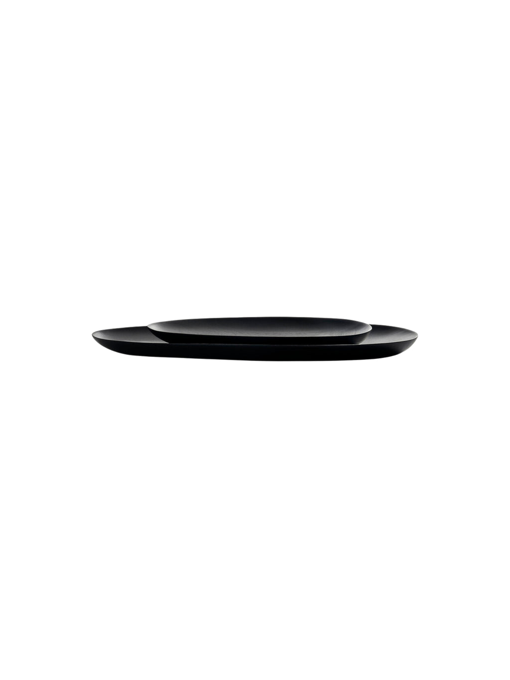 Ethnicraft Thin Oval Boards Set. A pair of sleek, minimalist dark black mahogany oval serving boards, stacked elegantly to showcase their thin profile and smooth, refined finish, displayed on a clean white background.