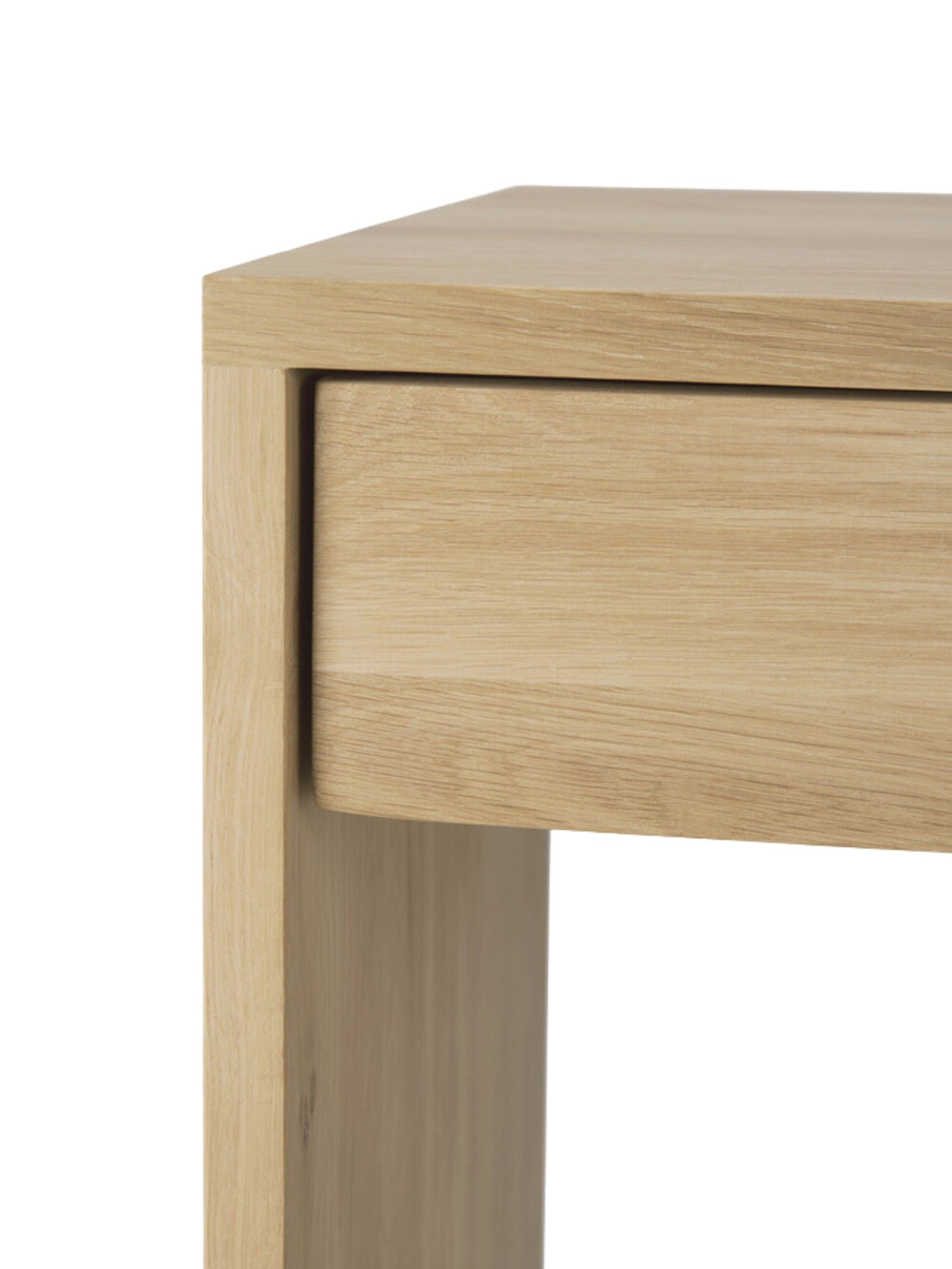 Ethnicraft Wave Desk, a sophisticated solid oak desk, showing a close-up of its closed, integrated drawer, emphasizing the seamless design and rich, natural grain of the light brown wood.