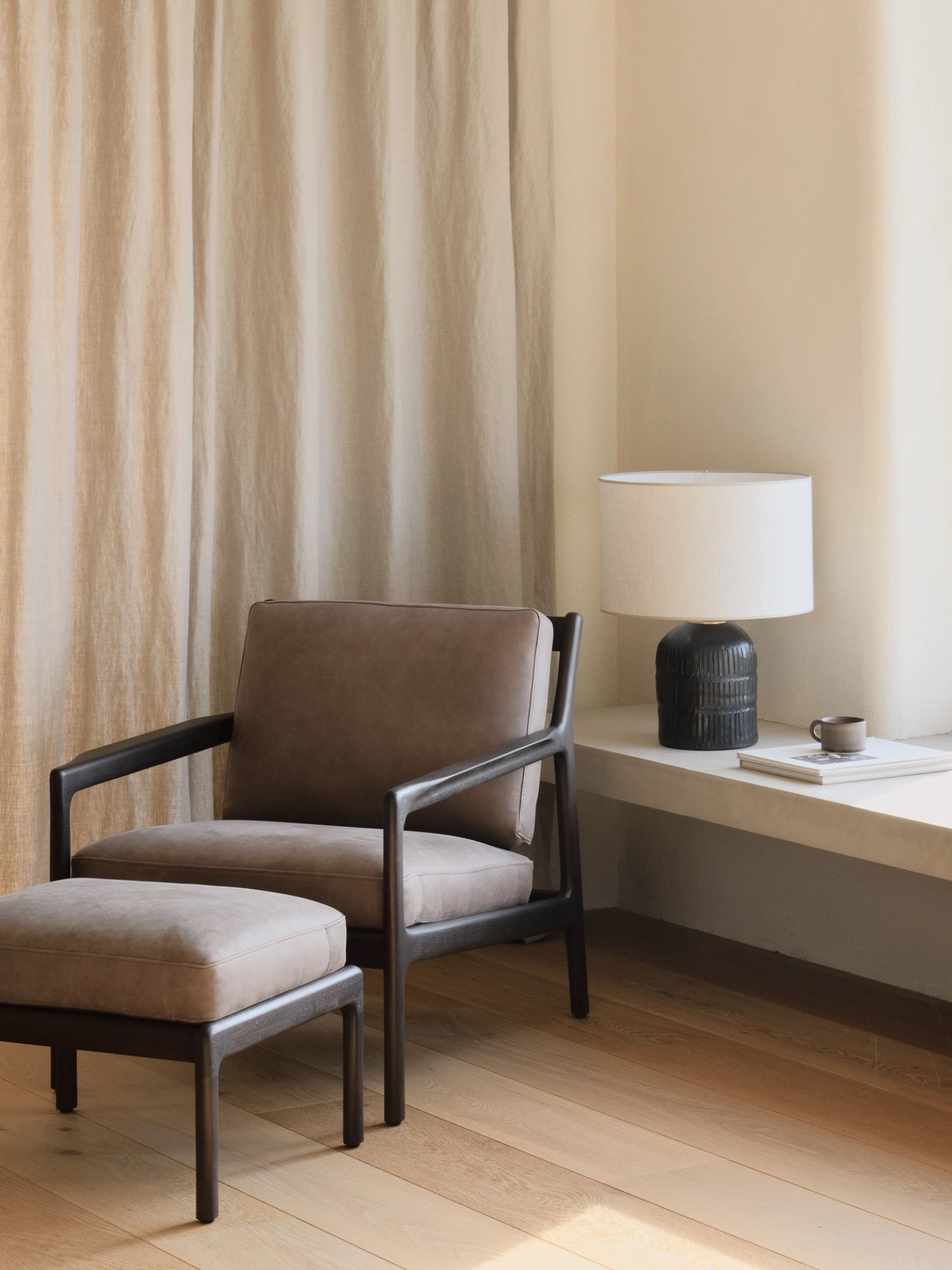 Ethnicraft Jack Lounge Chair, a sophisticated modern minimalist armchair crafted from dark solid oak, featuring a sleek, clean-lined frame with gently curved armrests and robust legs.
