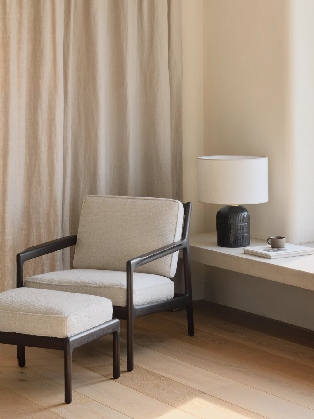 Ethnicraft Jack Lounge Chair, a contemporary organic modern lounge chair featuring a rich dark solid wood frame with elegantly curved armrests and a low-slung profile.
