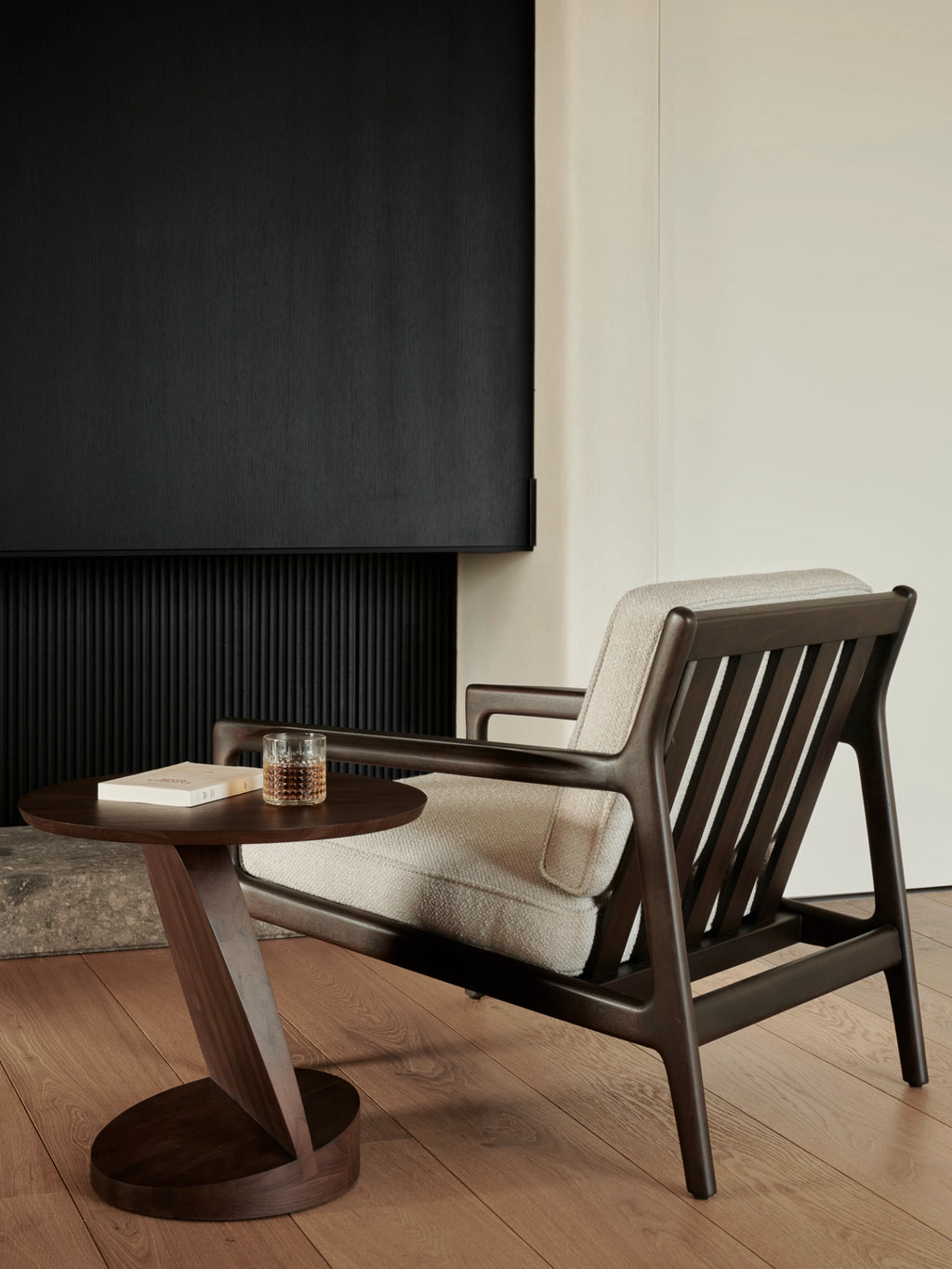 Ethnicraft Jack Lounge Chair, a sophisticated mid-century modern lounge chair featuring a rich dark solid wood frame with a distinctive slatted backrest and gently curved armrests, complemented by plush light cream textured fabric upholstery. This ergonomic and stylish armchair is perfect for creating a cozy reading nook or as a chic accent chair in a contemporary living room or bedroom.