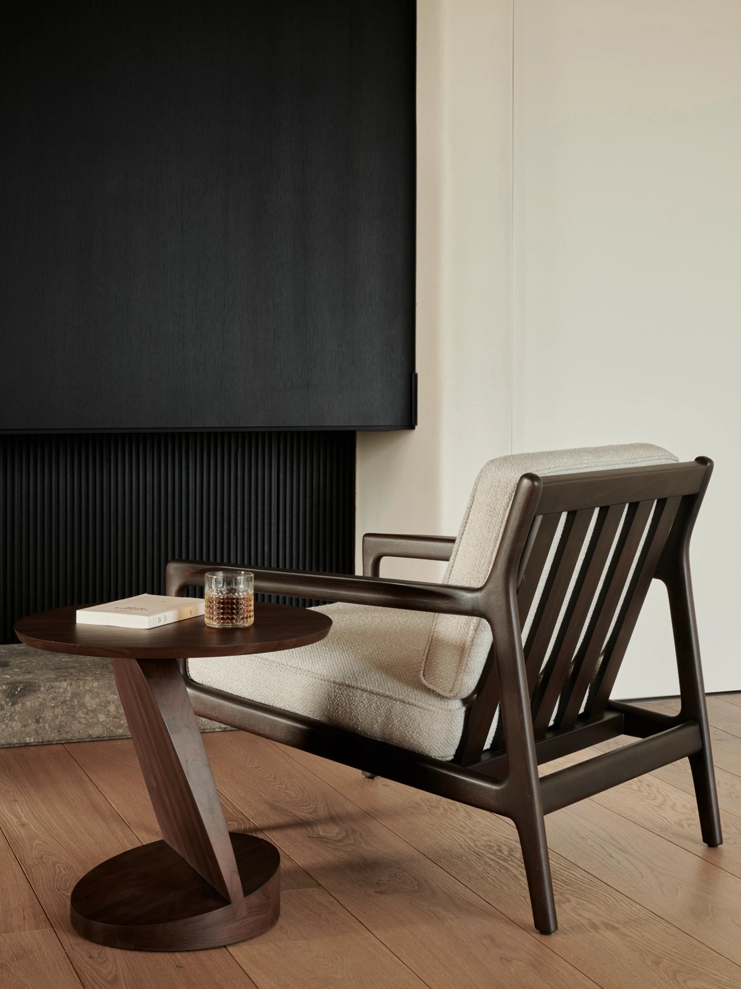 Ethnicraft Jack Lounge Chair, a sophisticated mid-century modern lounge chair featuring a rich dark solid wood frame with a distinctive slatted backrest and gently curved armrests, complemented by plush light cream textured fabric upholstery. This ergonomic and stylish armchair is perfect for creating a cozy reading nook or as a chic accent chair in a contemporary living room or bedroom.