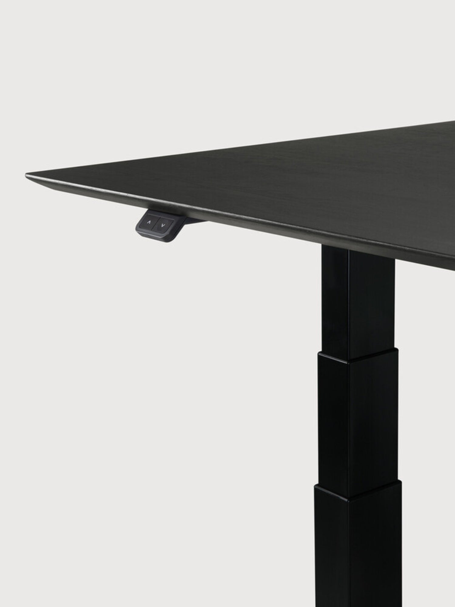 Ethnicraft Bok Adjustable Desk with black oak tabletop and black frame, a side profile showcasing the elegant, thin desk surface and the sturdy black adjustable height leg, with control buttons visible.