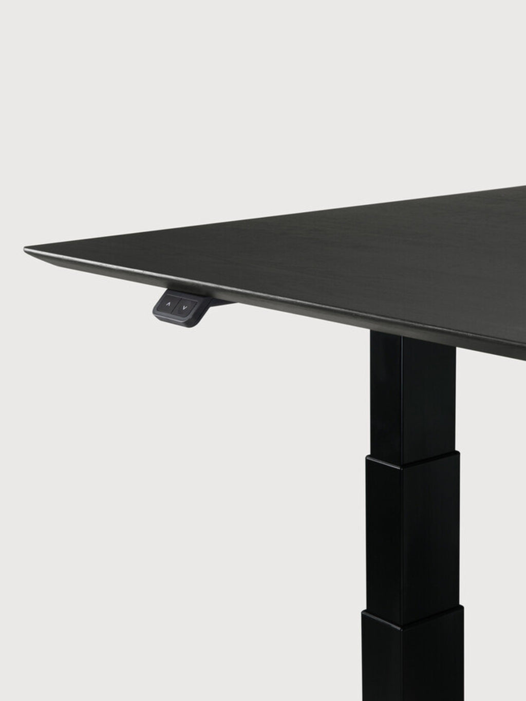 Ethnicraft Bok Adjustable Desk with black oak tabletop and black frame, a side view highlighting the sleek, thin tabletop edge and the robust black adjustable leg mechanism with control panel.