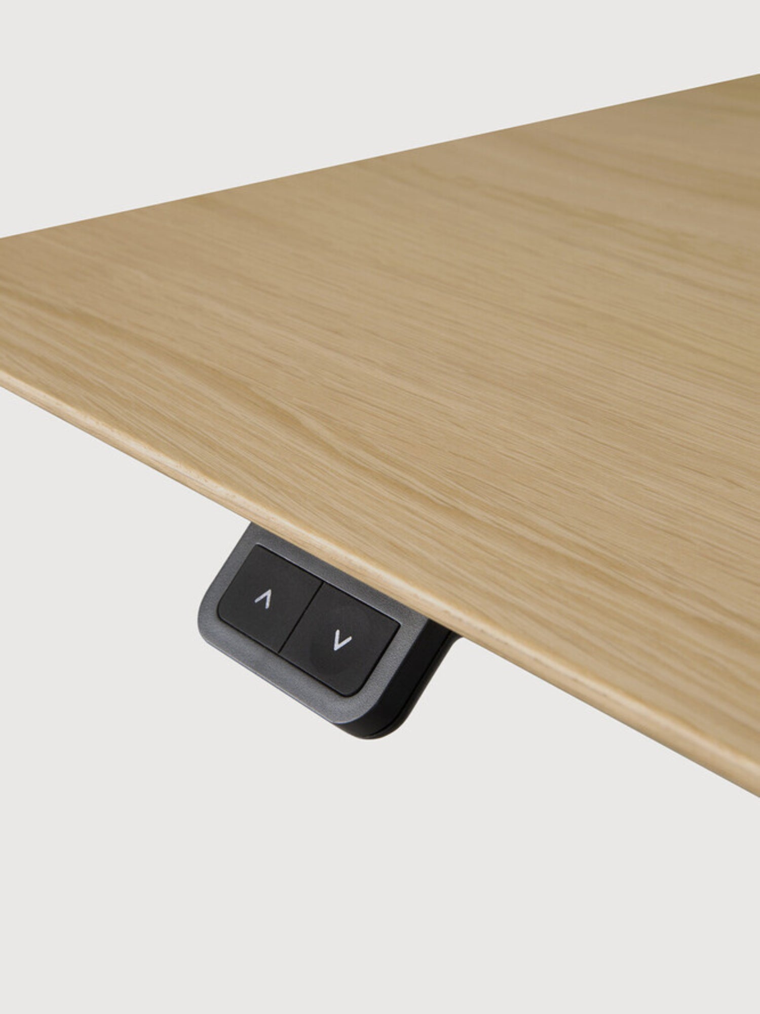 Ethnicraft Bok Adjustable Desk with white oak tabletop and white frame, a close-up showing the natural wood grain and the sleek, integrated control panel with up/down buttons on the desk's underside.