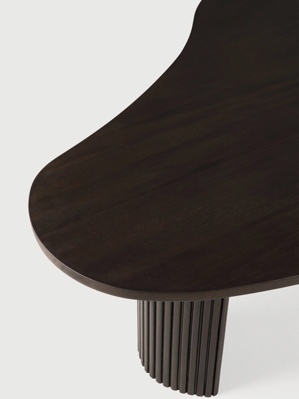Ethnicraft Boomerang Coffee Table in dark brown mahogany, a close-up detail highlighting the smooth, rich wood grain and the unique, organic boomerang shape.
