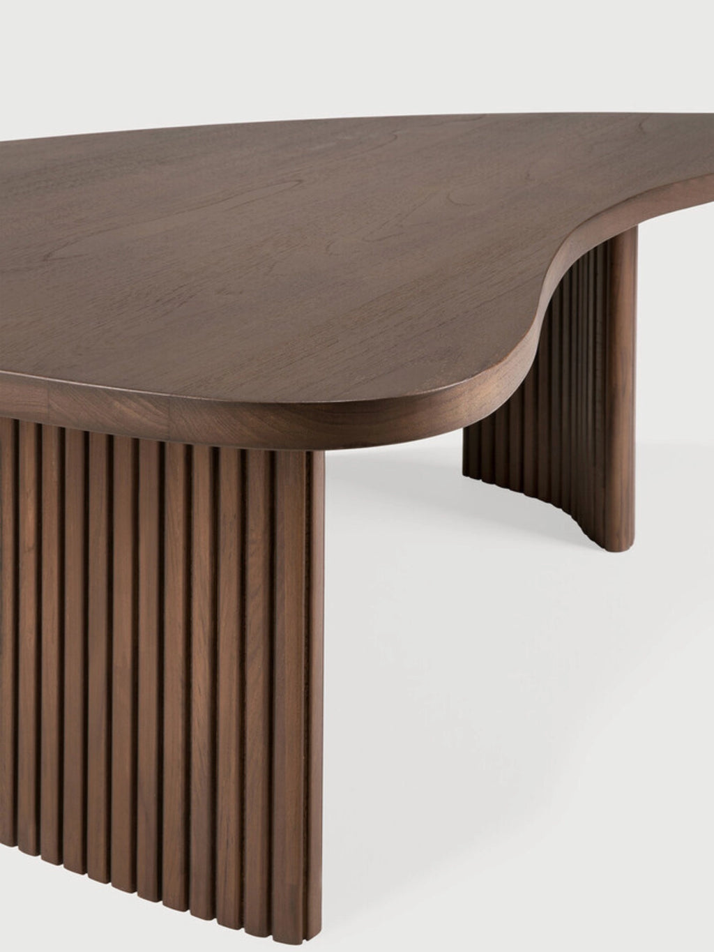 Ethnicraft Boomerang Coffee Table in rich brown teak wood, featuring a detailed view of its unique organic, kidney-shaped top and the distinctive fluted, curved leg structure, on a white background.