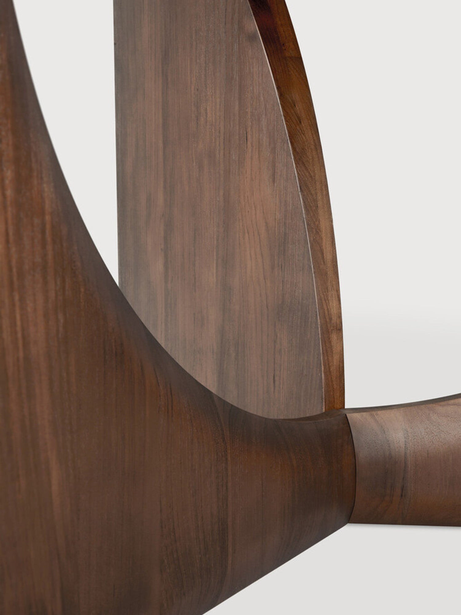 Ethnicraft Geometric Dining Table, a contemporary solid dark walnut wood dining table showcasing a beautifully sculptural and curved geometric base with a smooth, deep brown finish and natural wood grain. This elegant organic modern piece is ideal for creating a sophisticated focal point in modern dining rooms or minimalist kitchen areas.