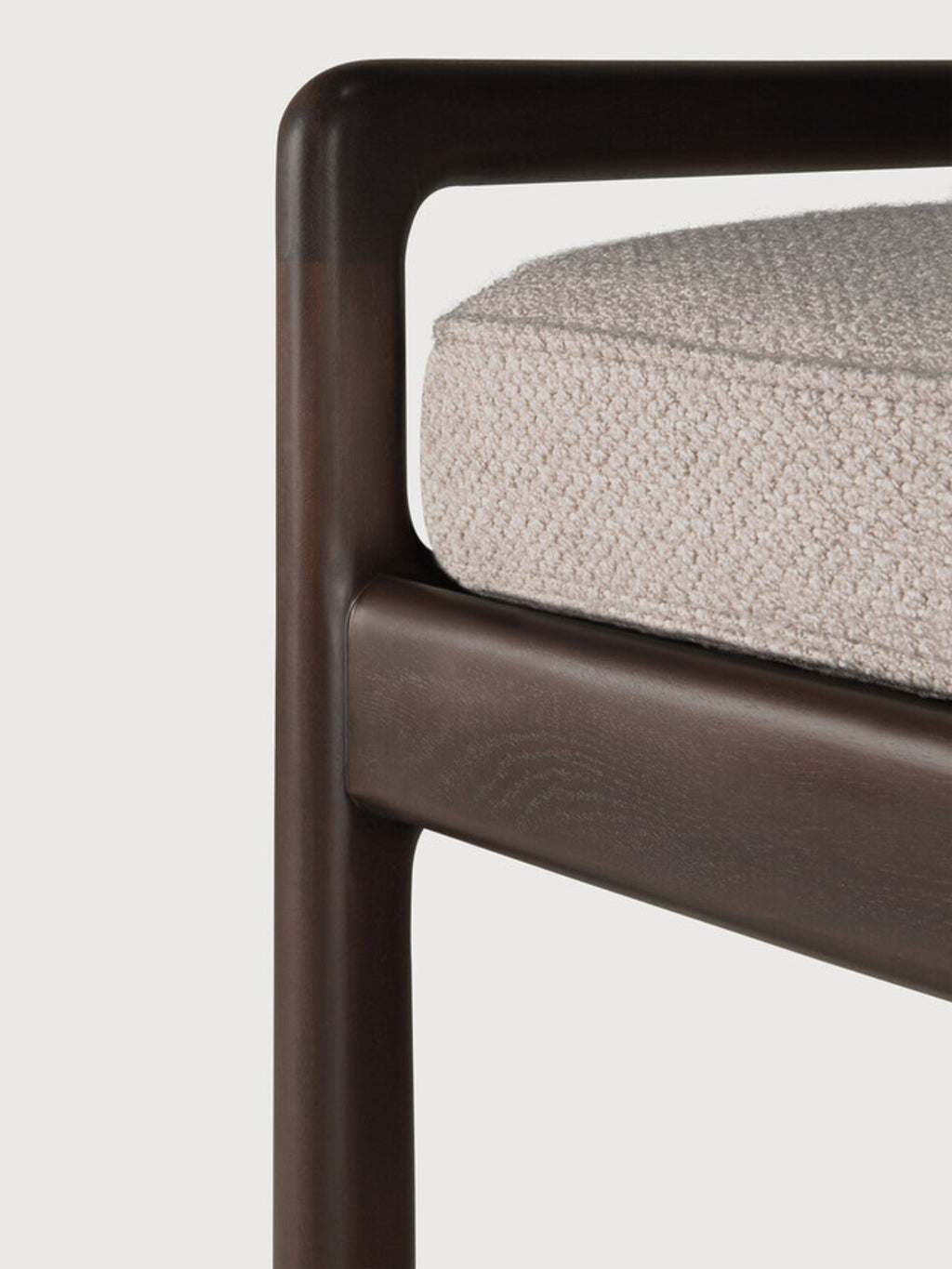 Ethnicraft Jack Bench, a detailed view of the elegant mahogany dark brown wooden frame and the soft ivory fabric cushion, emphasizing the seamless joinery and luxurious texture.