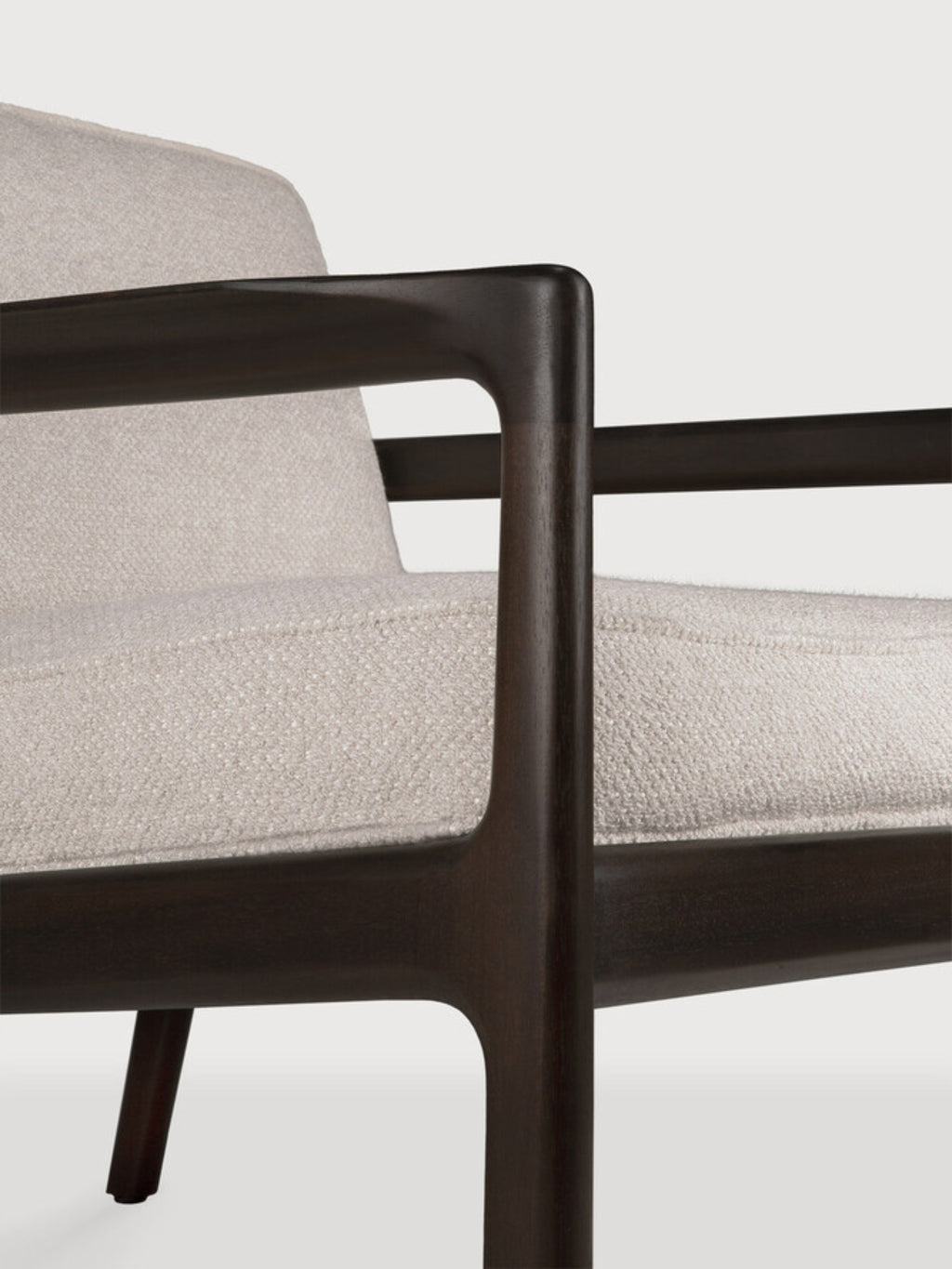 Ethnicraft Jack Lounge Chair, a modern armchair featuring a dark brown solid wood frame with smooth, gently curved armrests and legs, complemented by plush, light cream textured fabric cushions. This contemporary lounge chair is perfect for adding sophisticated comfort to living rooms or cozy reading nooks.
