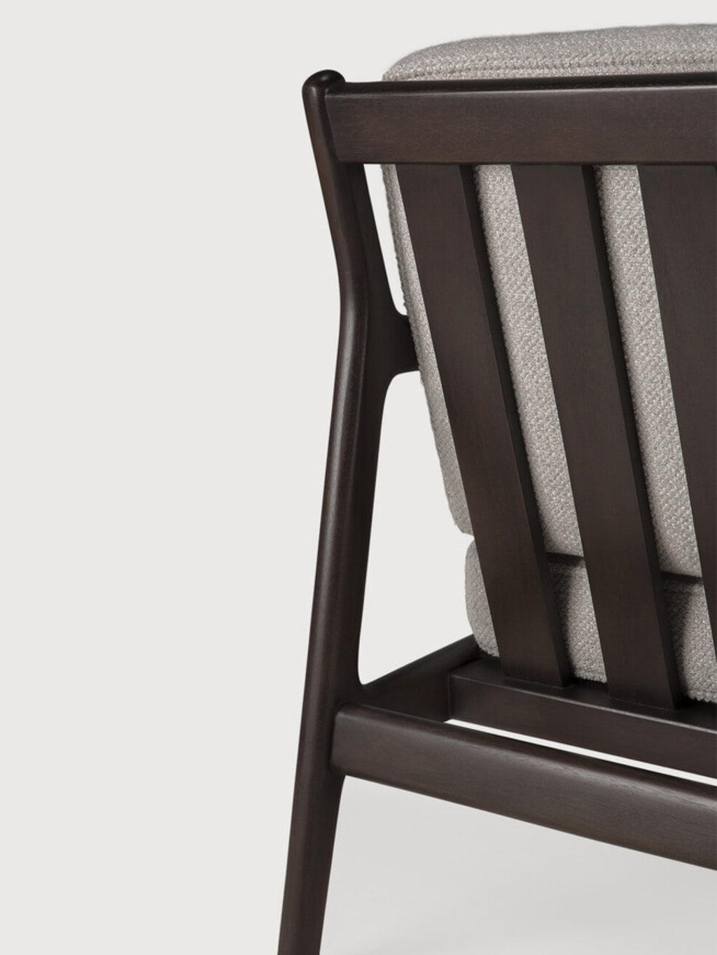 Ethnicraft Jack Lounge Chair, a sophisticated modern lounge chair crafted from dark solid wood with a slatted backrest and gently curved top rail, featuring plush light grey textured fabric cushions. This contemporary armchair offers deep seating comfort and clean lines, blending seamlessly into organic modern or mid-century inspired living rooms and reading nooks.