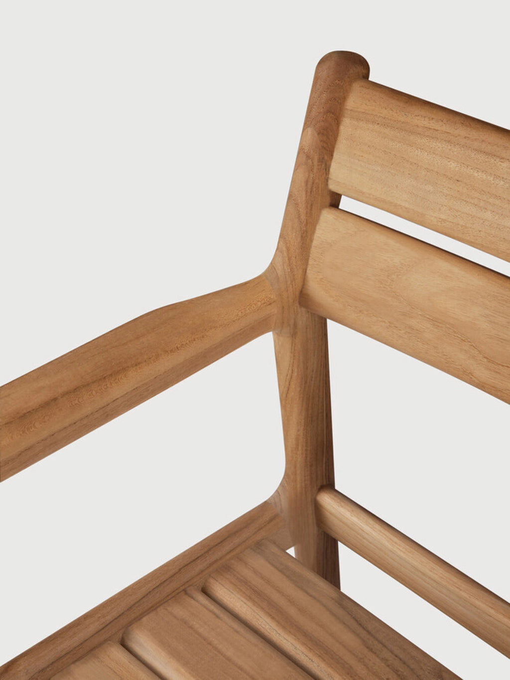 Ethnicraft Jack Outdoor Dining Chair With Armrest, a contemporary outdoor dining chair crafted from durable solid teak wood with a warm natural honey finish and visible wood grain. It features a minimalist design with a slatted seat and backrest, and elegantly curved armrests that flow into the frame, perfect for modern patio dining areas or garden furniture setups.