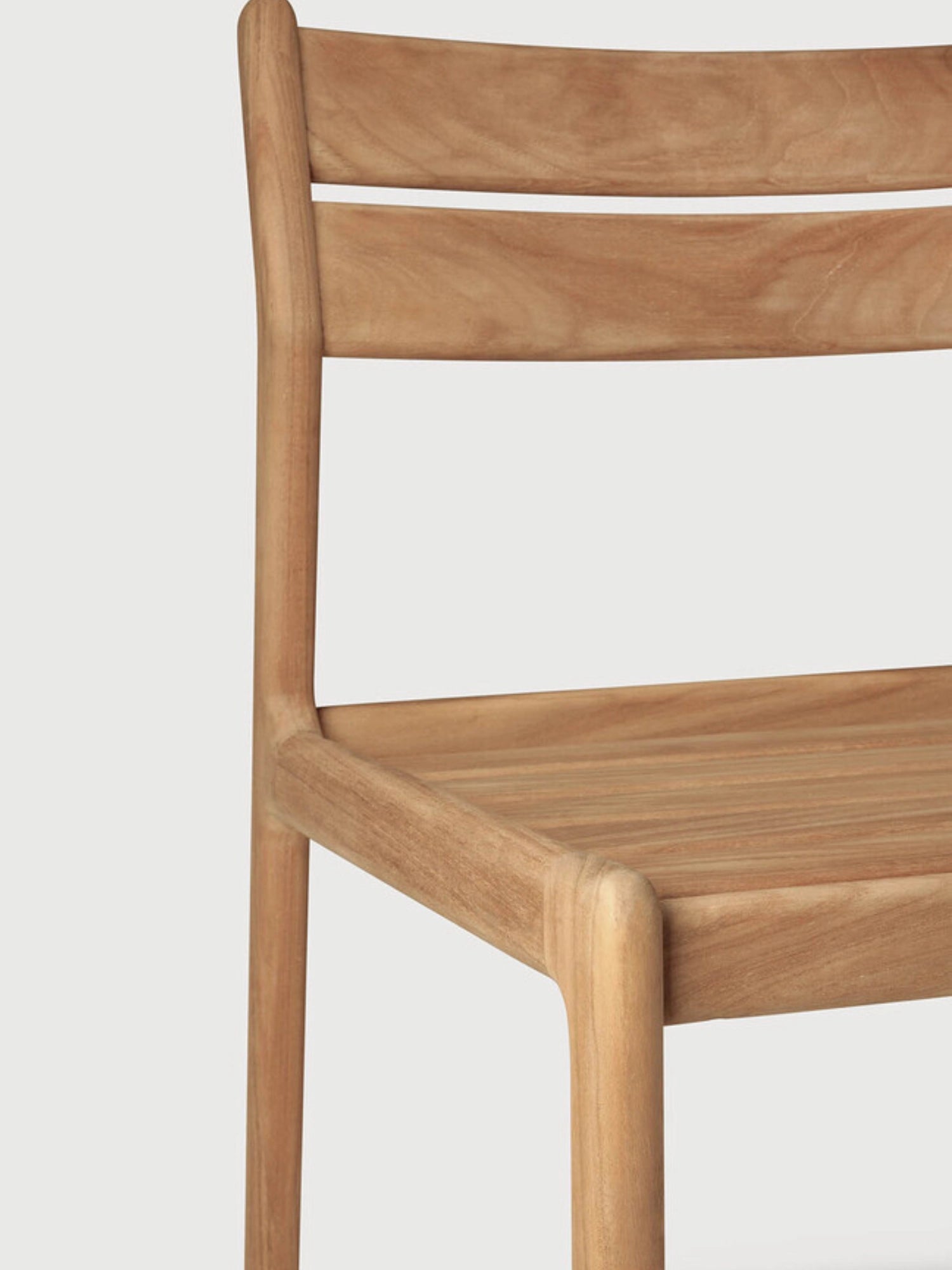 Ethnicraft Jack Outdoor Dining Chair Without Armrest, a modern minimalist dining chair crafted from warm natural solid teak wood with a smooth finish and visible grain. It features a clean, curved silhouette with a slatted backrest and gently sculpted seat for ergonomic comfort. Ideal as an outdoor dining chair for contemporary patios, gardens, and deck areas seeking Scandinavian-inspired design.