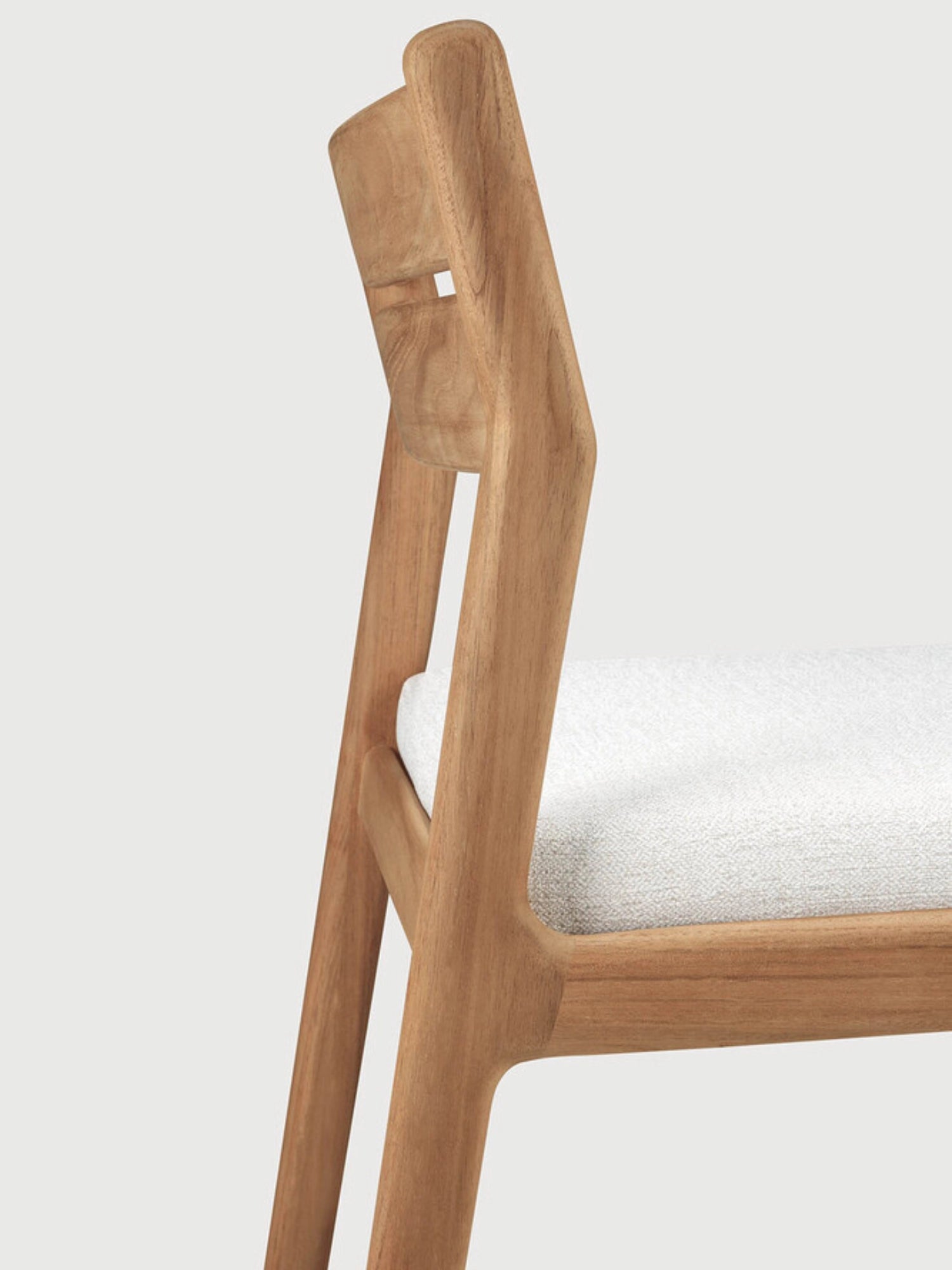 Ethnicraft Jack Outdoor Dining Chair Without Armrest, a modern minimalist dining chair crafted from durable solid teak wood with a smooth natural finish and a subtly curved backrest featuring a rectangular cutout. It features a comfortable light grey upholstered seat, ideal for contemporary outdoor dining areas, patios, or garden spaces.