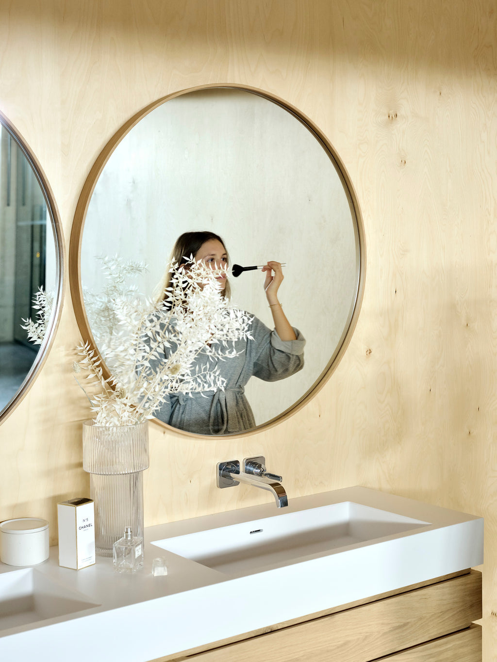 Ethnicraft Layers Wall Mirror, a modern minimalist round mirror featuring a natural light wood frame with a clean, circular silhouette, designed to create an elegant layered effect when hung together. This Scandinavian-inspired wood framed mirror is perfect for a contemporary bathroom vanity or as a stylish accent in an organic modern living space.