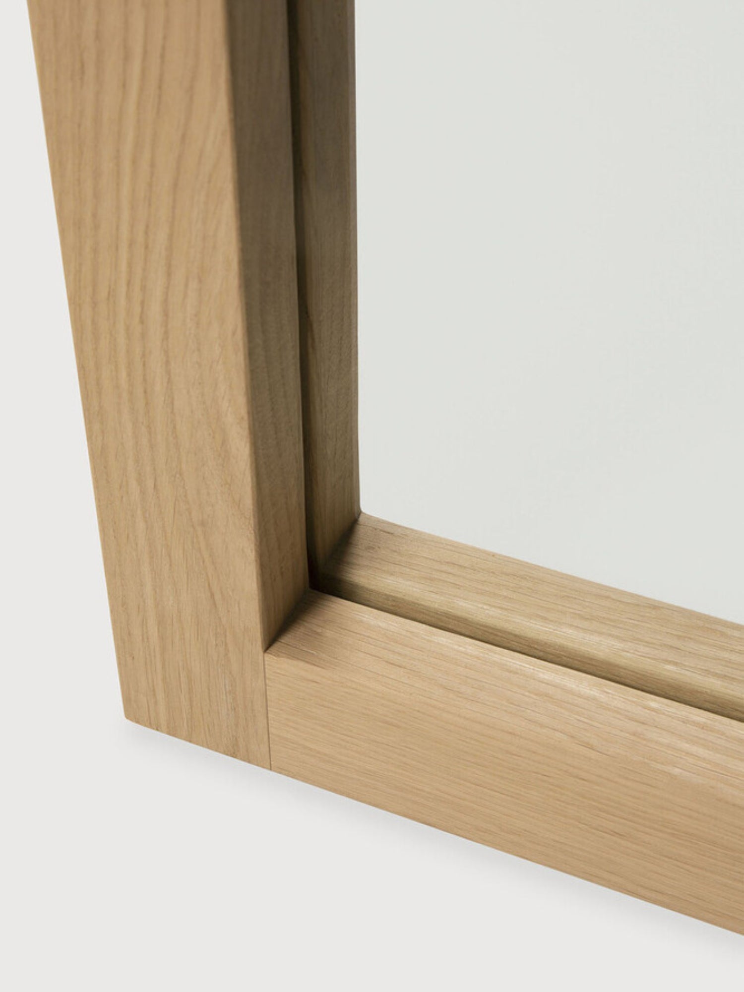 Ethnicraft Light Frame Floor Mirror, a modern minimalist full-length mirror crafted from natural solid oak wood with a visible grain and a clean, sculptural frame design. This elegant Scandinavian-inspired piece offers a subtle organic modern aesthetic for contemporary living room decor, bedroom accents, or stylish entryway statements.