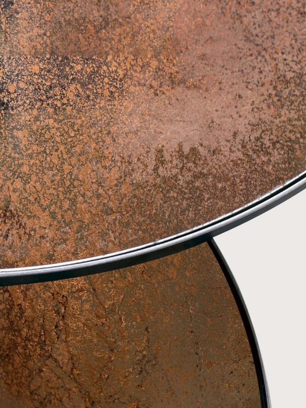 Ethnicraft Nesting Coffee Table Set, featuring round table tops with a rich, textured patinated metal finish in coppery brown and dark bronze tones, framed by sleek black metal edges.