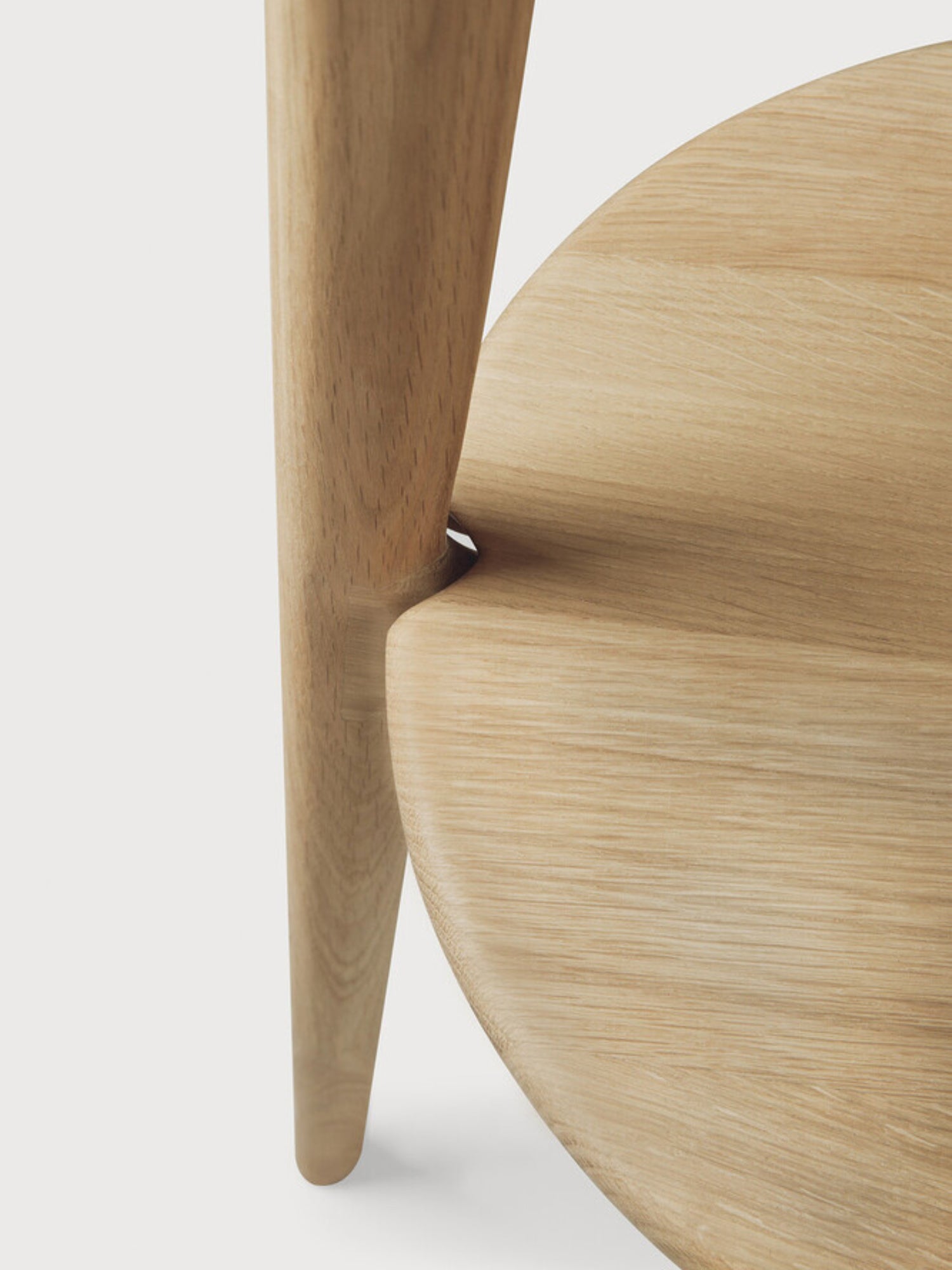 Ethnicraft PI Coat Stand, a modern minimalist coat rack crafted from light natural solid oak wood with a smooth, visible grain and elegant, rounded forms. Its sculptural design features a robust conical leg seamlessly joining a circular base, creating a sophisticated organic modern aesthetic. Perfect for enhancing entryways, hallways, or bedrooms in contemporary Scandinavian-inspired homes.