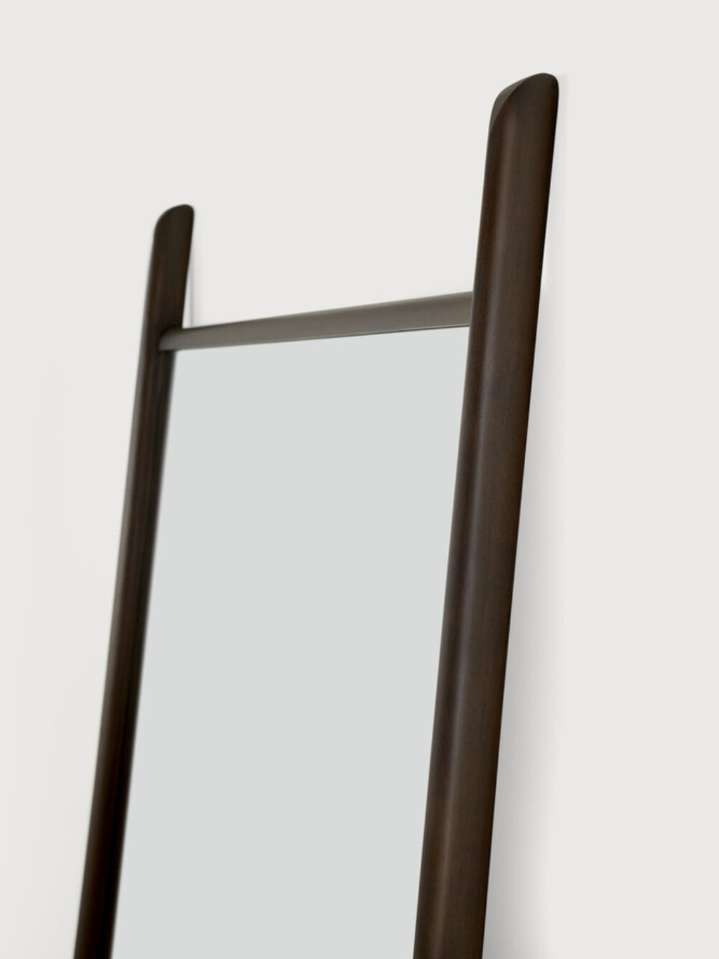Ethnicraft PI Floor Mirror, a full-length modern minimalist leaning mirror featuring a dark brown solid wood frame with rounded, organic edges and a sleek dark metal accent bar. This contemporary wood floor mirror is perfect for adding functional style to a bedroom, entryway, or modern living room.