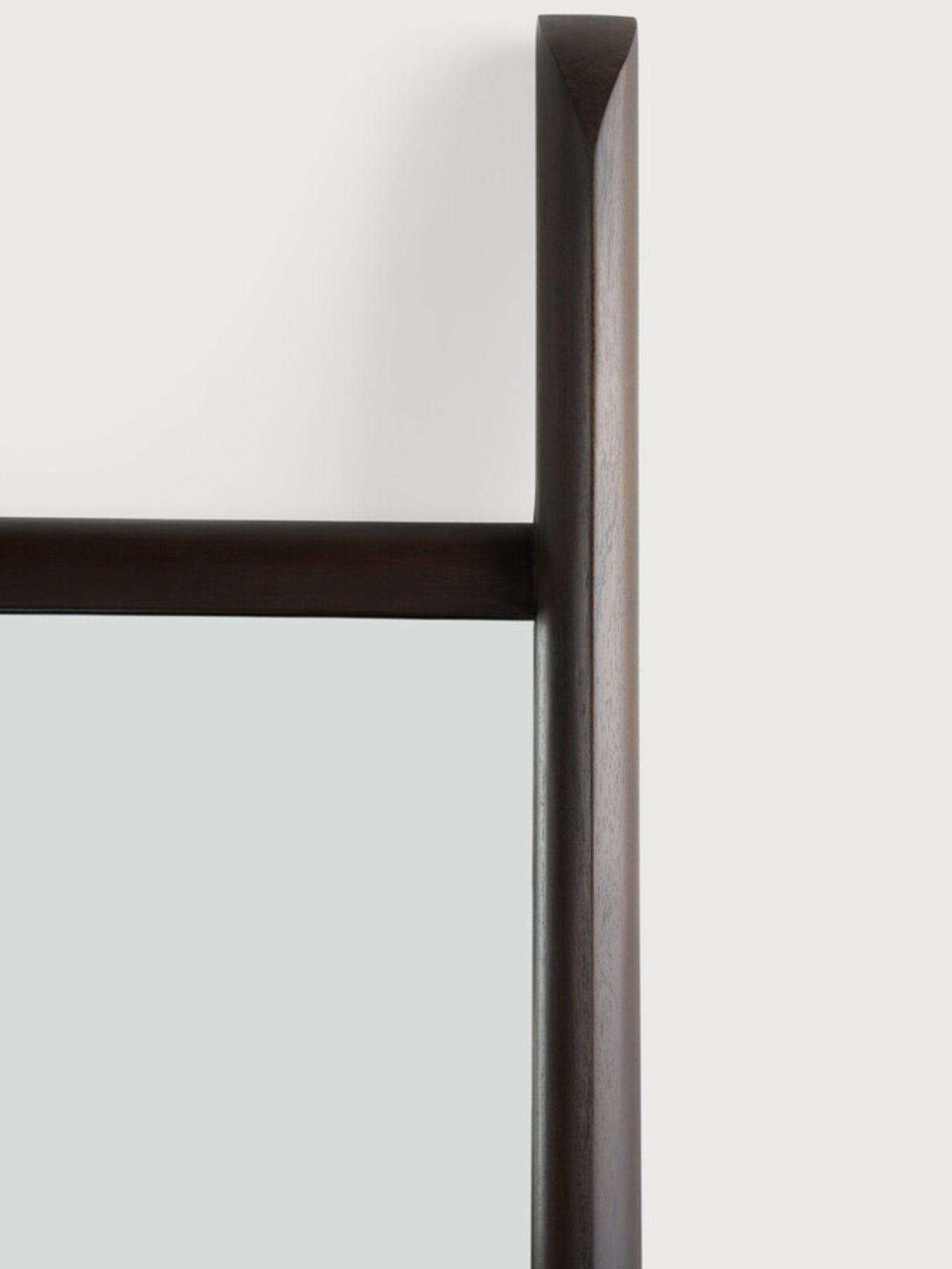 Ethnicraft PI Floor Mirror, a minimalist dark brown solid wood floor mirror featuring a thick, rounded frame with a smooth finish and distinctive angled top edges, crafted from rich dark-stained wood. Its contemporary organic modern design makes it an ideal full-length mirror for a modern living room, Scandinavian bedroom, or sophisticated entryway, adding depth and style to any space.
