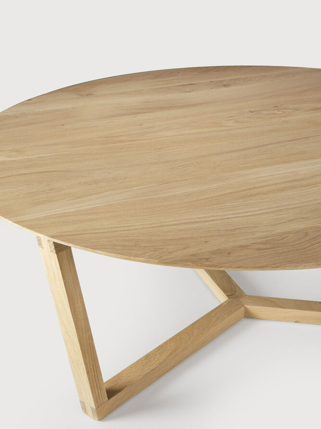 Ethnicraft Tripod Coffee Table, a modern round oak coffee table with a light natural wood grain, showcasing the elegant, sturdy tripod base design on a clean white background.