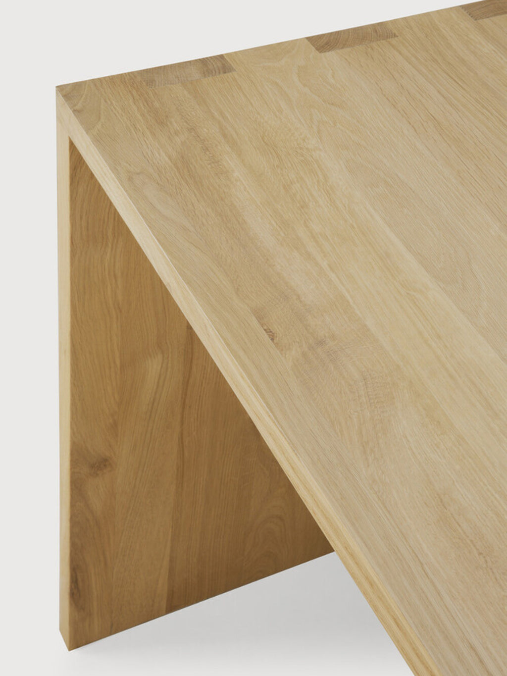Ethnicraft U Desk, an angled shot revealing the robust, U-shaped design and the beautiful natural oak wood grain, emphasizing its modern, clean lines and solid construction.