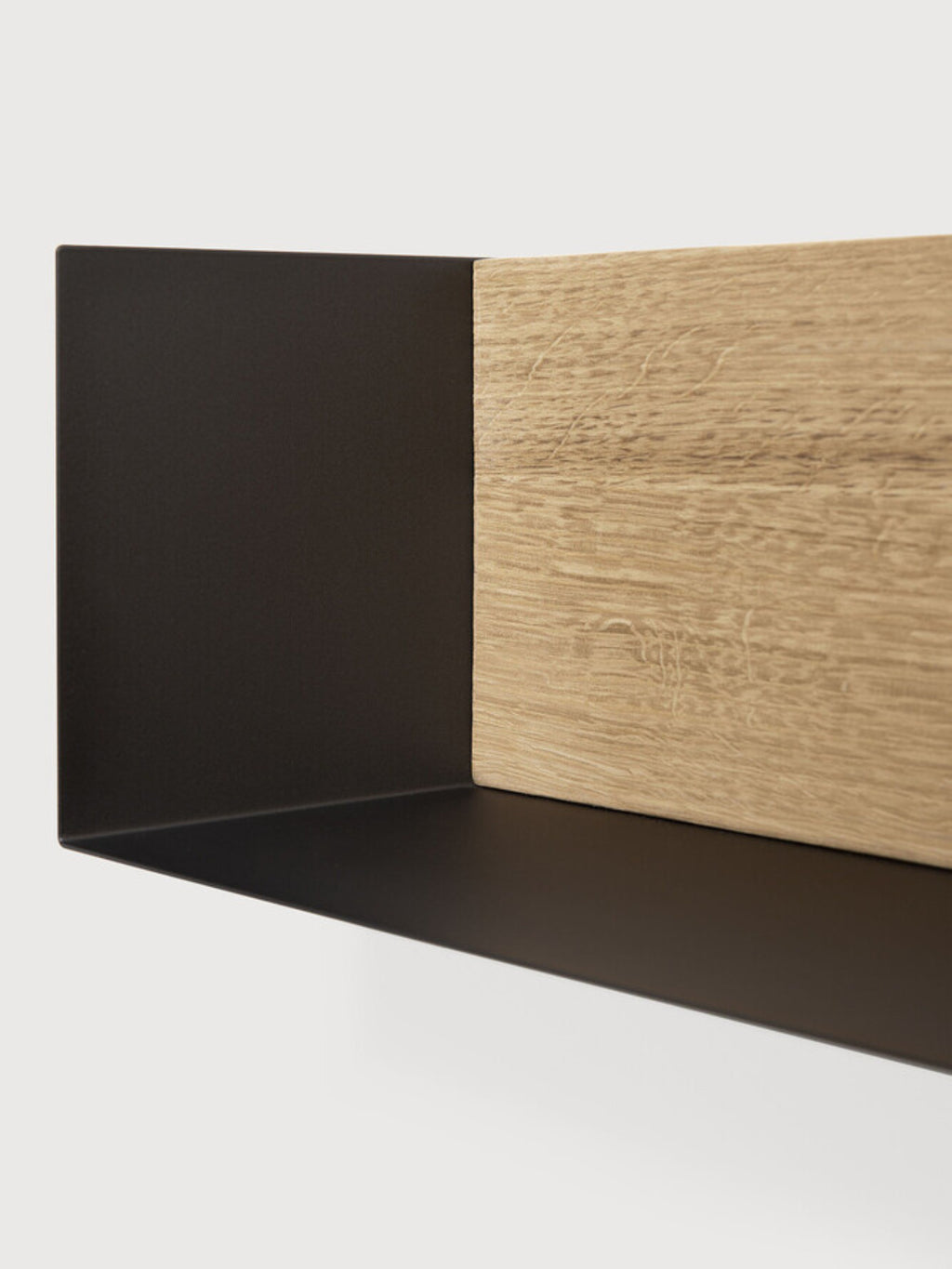 Ethnicraft U Shelf, a modern minimalist wall shelf crafted from matte black metal with a natural oak wood insert. Its sleek U-shaped profile offers clean lines and a contemporary aesthetic. This black metal and oak floating shelf combines the durability of powder-coated steel with the warmth of genuine wood grain, ideal for Scandinavian living rooms, industrial chic home offices, or.