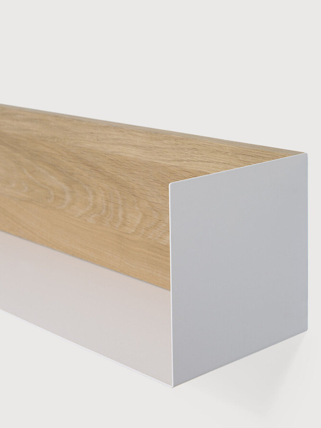 Ethnicraft U Shelf, a modern minimalist wall shelf featuring a natural light oak wood panel elegantly encased within a sleek matte white metal U-shaped frame, creating clean lines and a contemporary aesthetic. This Scandinavian-inspired floating shelf is perfect for stylish wall storage or display in living rooms, bedrooms, or home offices.