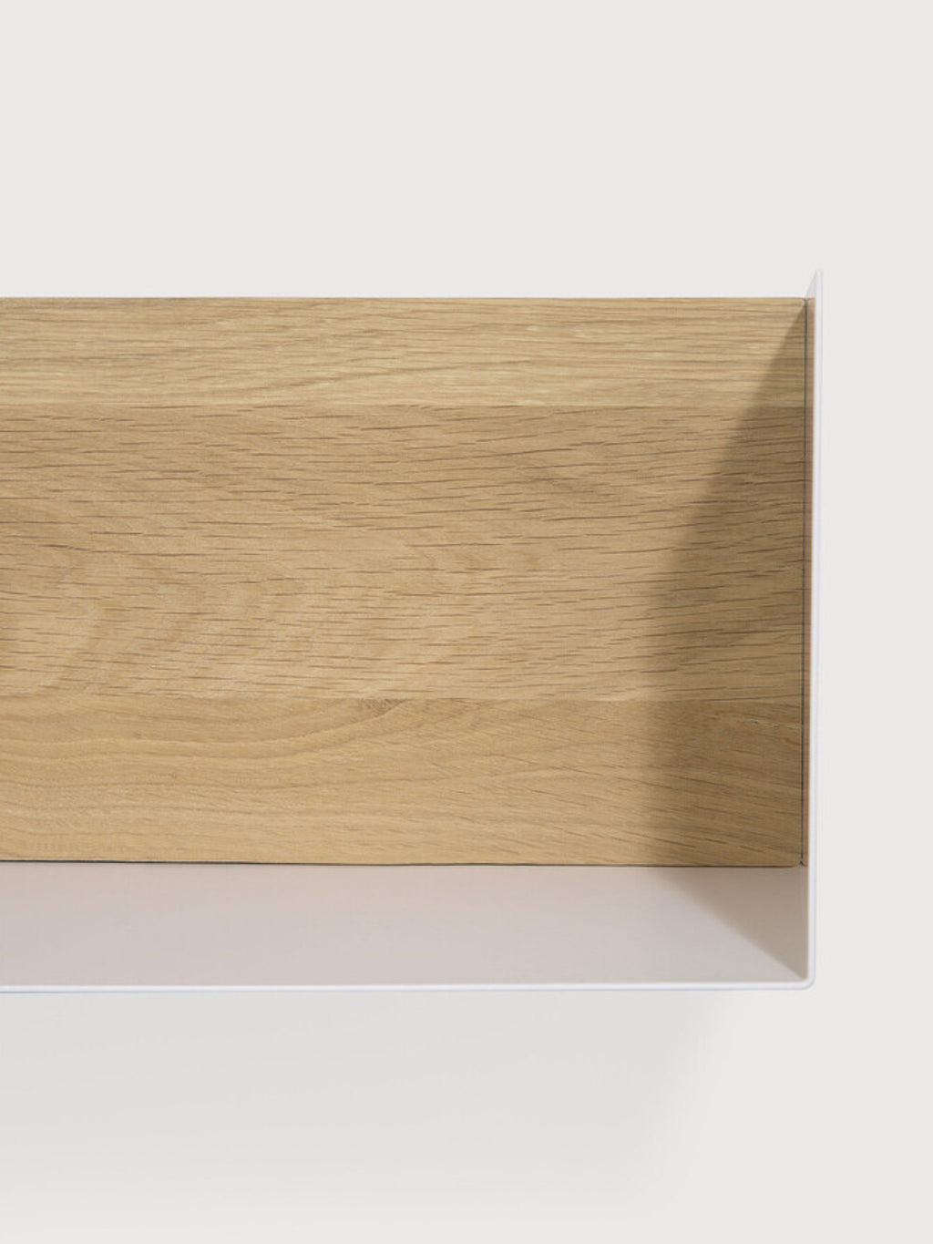 Ethnicraft U Shelf, a modern minimalist floating shelf featuring a natural light oak wood front panel with visible grain texture, elegantly framed by a crisp matte white metal U-shaped structure. The internal back of the shelf is a subtle light greige, creating clean Scandinavian lines for contemporary interiors. Ideal for stylish wall storage in living rooms, bedrooms, or home office shelf styling.