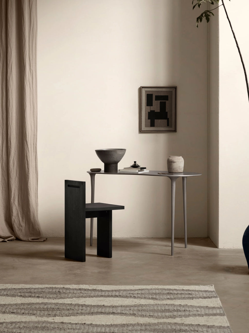 Tine K Dune Recycled Aluminium Desk, a light grey recycled aluminum desk with a smooth matte finish, featuring an elongated oval top and slender, organically shaped tapered legs. This sculptural and minimalist design is perfect as a contemporary home office desk, modern living room console table, or elegant entryway accent for organic modern interiors.