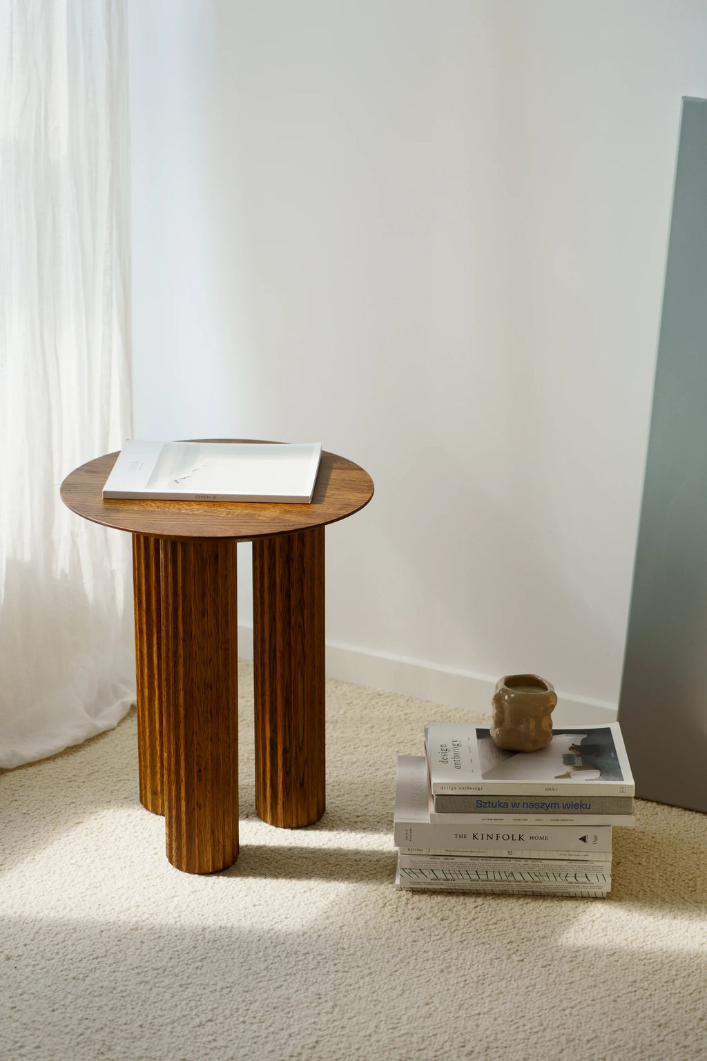 TAMO Filar Side Table, a round-top luxury wooden side table in rich brown, featuring three fluted, cylindrical legs. Perfect for modern living spaces.