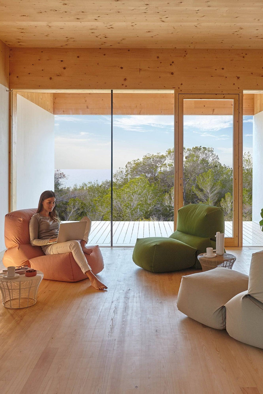 GAN Rugs Grapy Lounge Chair, a versatile organic modern lounge chair with a soft, plush, and conforming beanbag-style shape, upholstered in a warm terracotta-toned fabric with visible stitching.