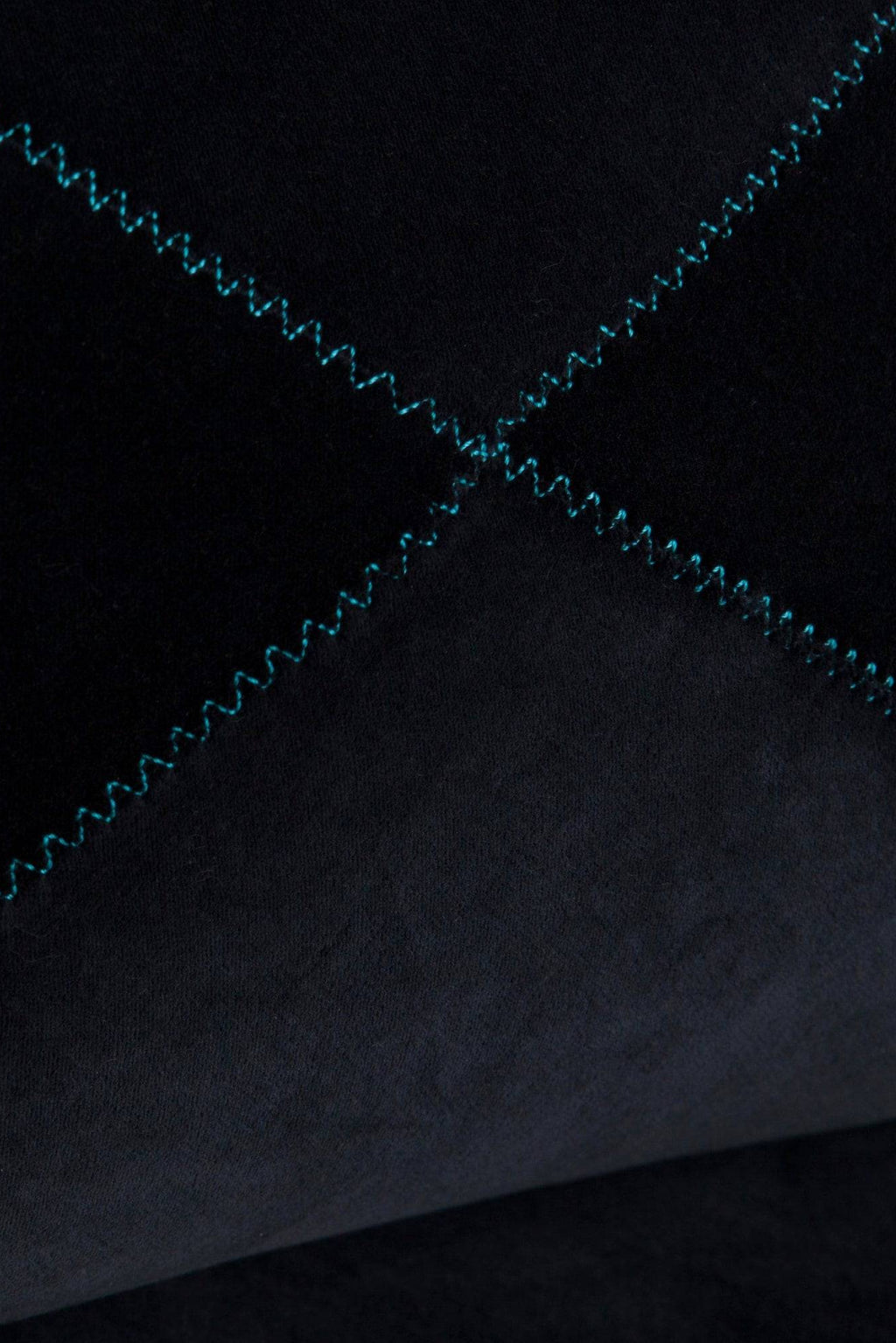 GAN Rugs Grapy Lounge - Velvet, a luxurious modern lounge chair upholstered in deep black velvet fabric, featuring a distinctive quilted diamond pattern with vibrant turquoise zig-zag contrast stitching. This contemporary piece is ideal for adding a touch of chic comfort to a living room, media room, or as a stylish bedroom accent.