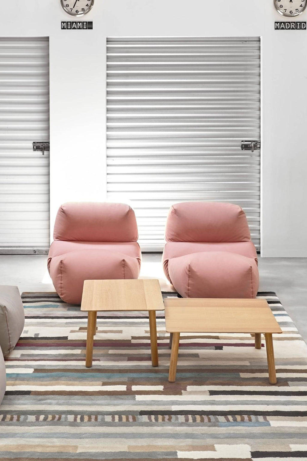 GAN Rugs Grapy Lounge Chair, a soft, oversized lounge chair upholstered in a muted dusty rose fabric, featuring a relaxed, organic shape with visible stitching details and a plush, comfortable silhouette. This contemporary low-profile armchair is perfect for creating a cozy reading nook or adding a casual accent to a modern living room or bedroom.