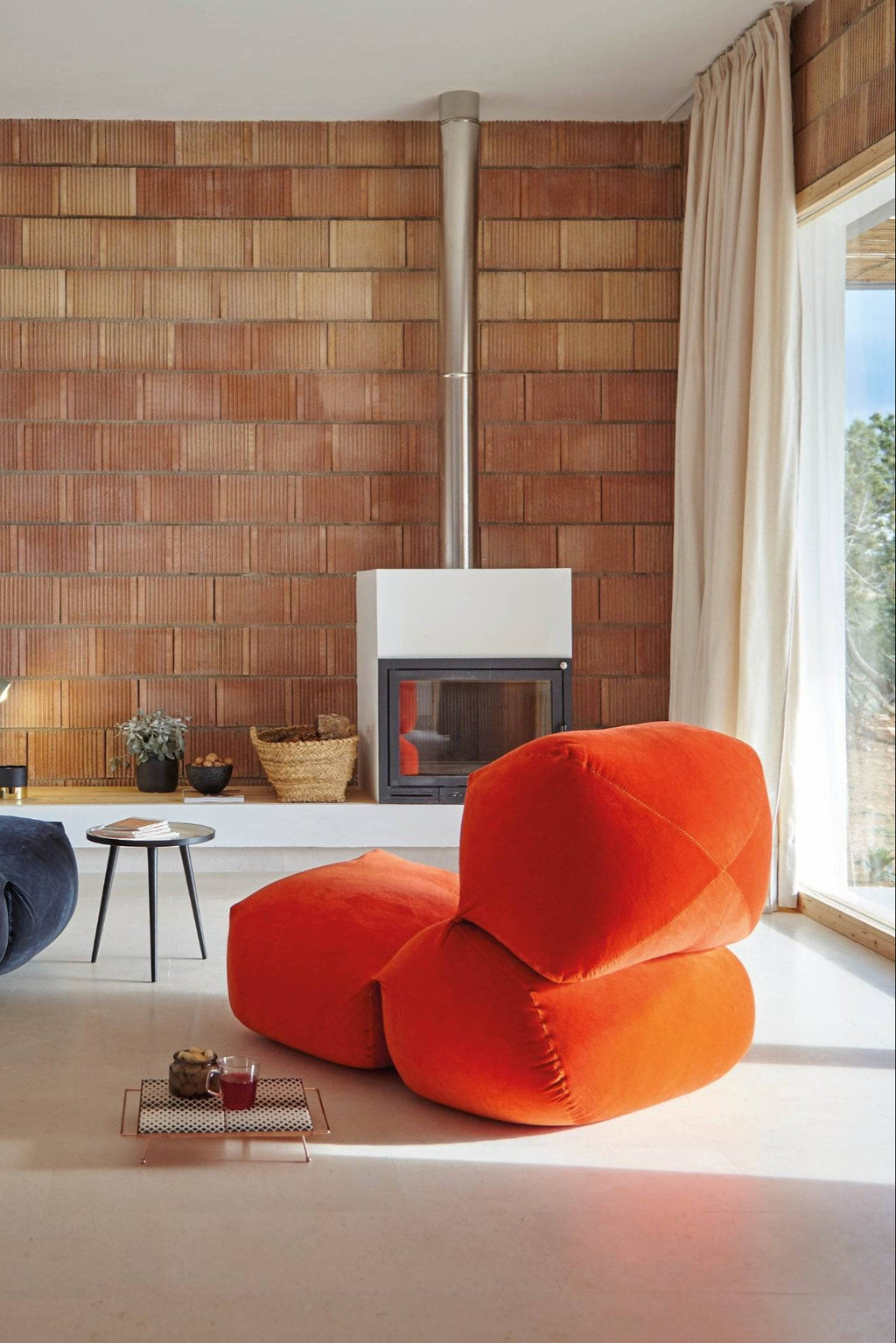 GAN Rugs Grapy Lounge - Velvet, a vibrant orange oversized lounge chair upholstered in plush velvet fabric, featuring an organic, beanbag-inspired shape with visible stitching details. This contemporary floor seating is perfect for creating a relaxed living room atmosphere or a cozy reading nook in modern minimalist homes.