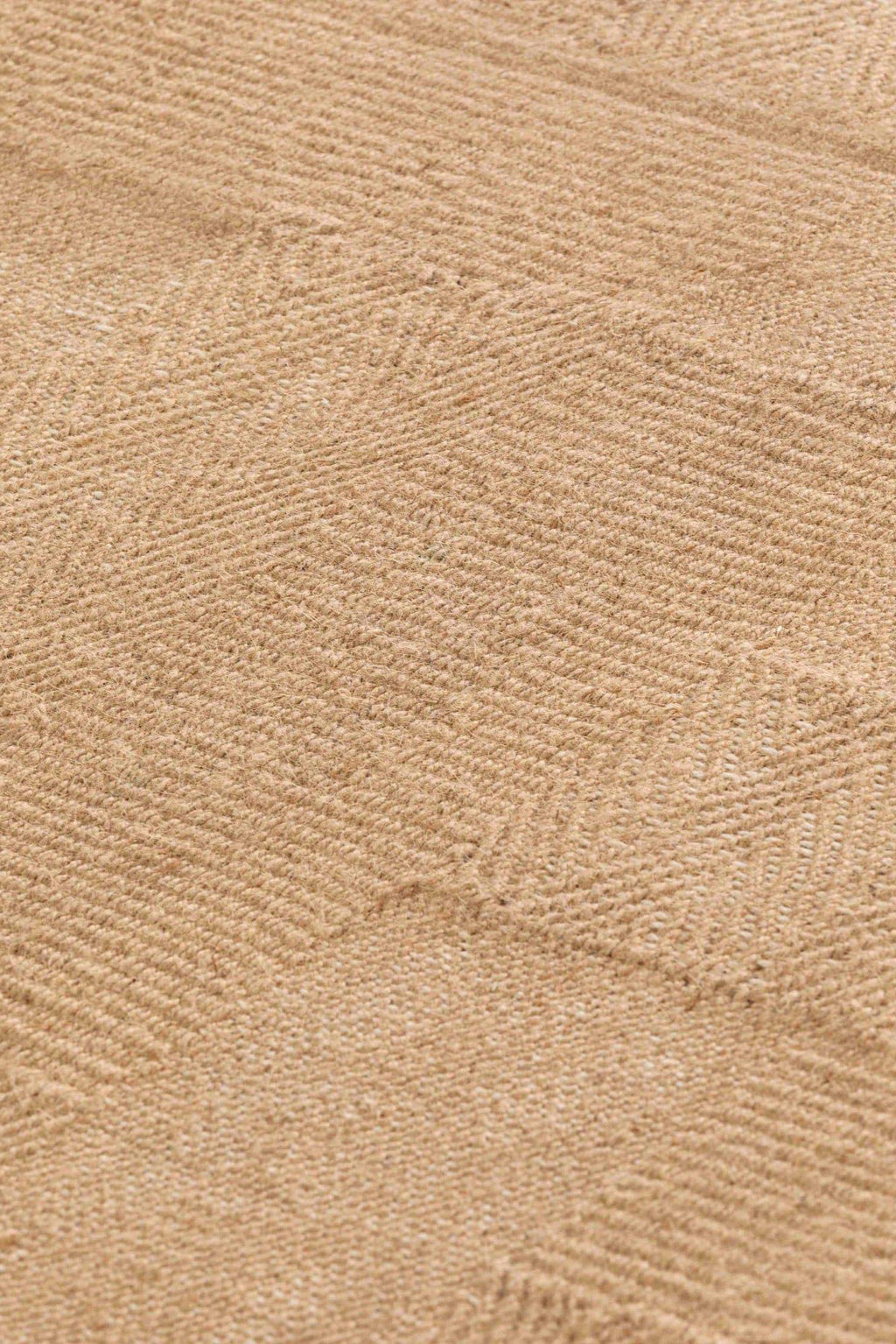 GAN Rugs Roots 04 Rug, a premium hand-woven natural fiber area rug in a warm, undyed beige tone, featuring a prominent textured chevron weave for a dynamic, organic pattern. Crafted from durable, coarse jute or sisal fibers, its rustic appeal and natural texture create a grounding foundation.