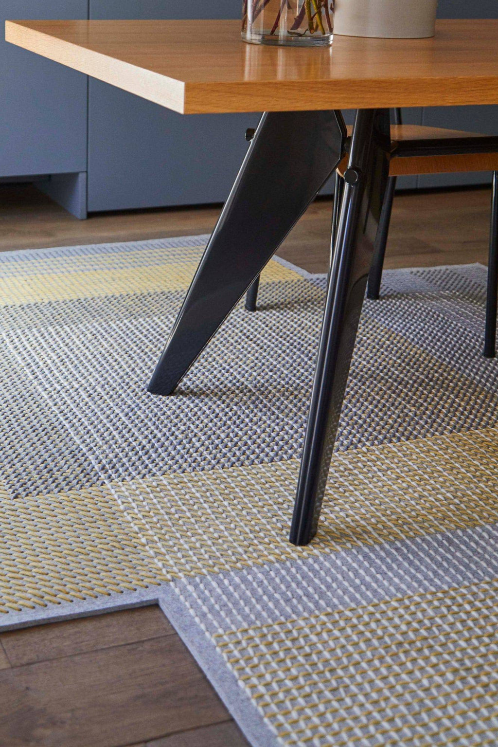 GAN Rugs Canevas Geo Rug, a modern geometric area rug featuring a distinctive textured weave in contrasting blocks of cool grey, vibrant yellow, and crisp white.