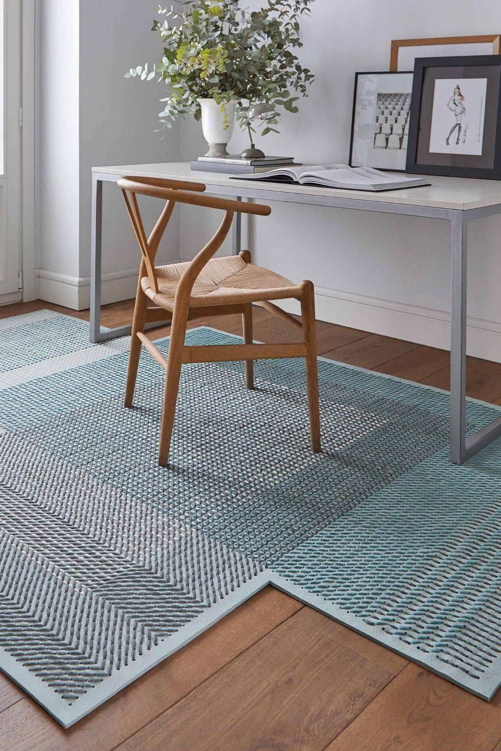 GAN Rugs Canevas Geo Rug, a modern geometric area rug featuring a distinctive hand-stitched texture in shades of vibrant teal, soft aqua blue, and light grey.