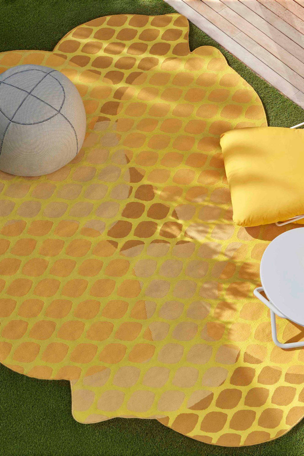 GAN Rugs Citrus Outdoor Rug, a vibrant yellow outdoor area rug featuring an organic, irregular shape reminiscent of a citrus slice. Its playful contemporary design showcases an overlapping oval pattern in shades of bright yellow, lime green, and warm orange, creating a dynamic gradient effect. This durable woven patio rug is perfect for adding a bold pop of color and modern style to outdoor living spaces, decks, and garden areas.