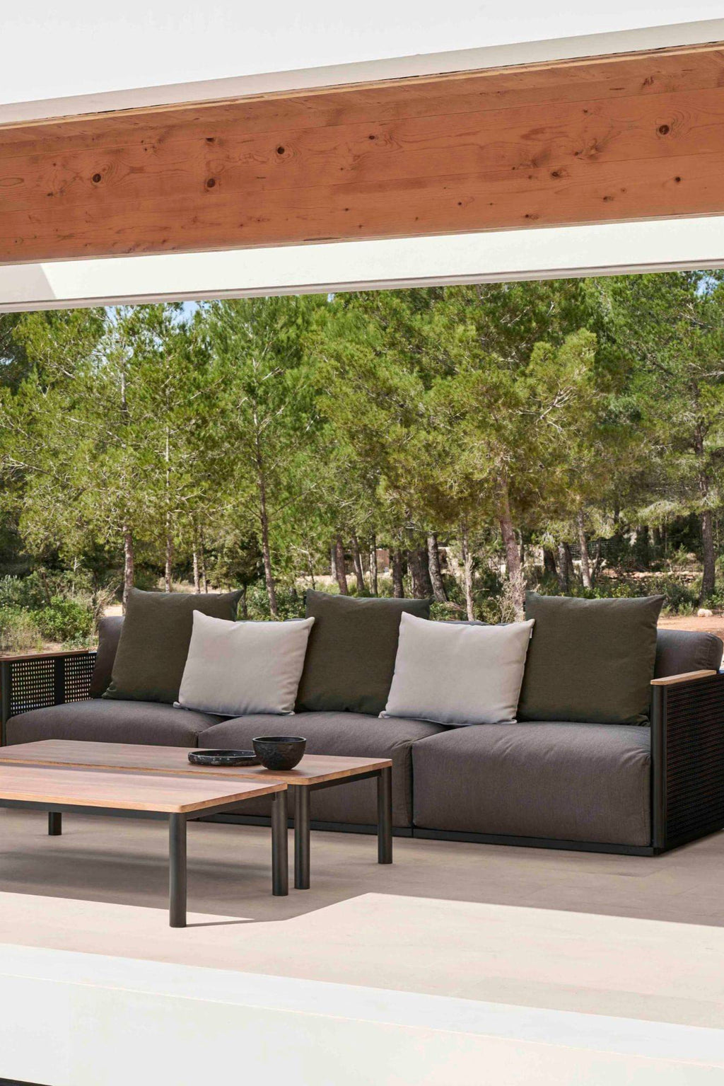 Gandia Blasco Bosc 3-Seater Sofa, a modern outdoor lounge sofa featuring a sleek matte black aluminum frame with a textured woven mesh base and dark grey upholstered cushions. This contemporary outdoor sectional includes olive green back cushions and light grey accent pillows, complemented by natural wood armrest details. Perfect for creating a stylish outdoor living room or luxury patio seating in Mediterranean or minimalist garden spaces.