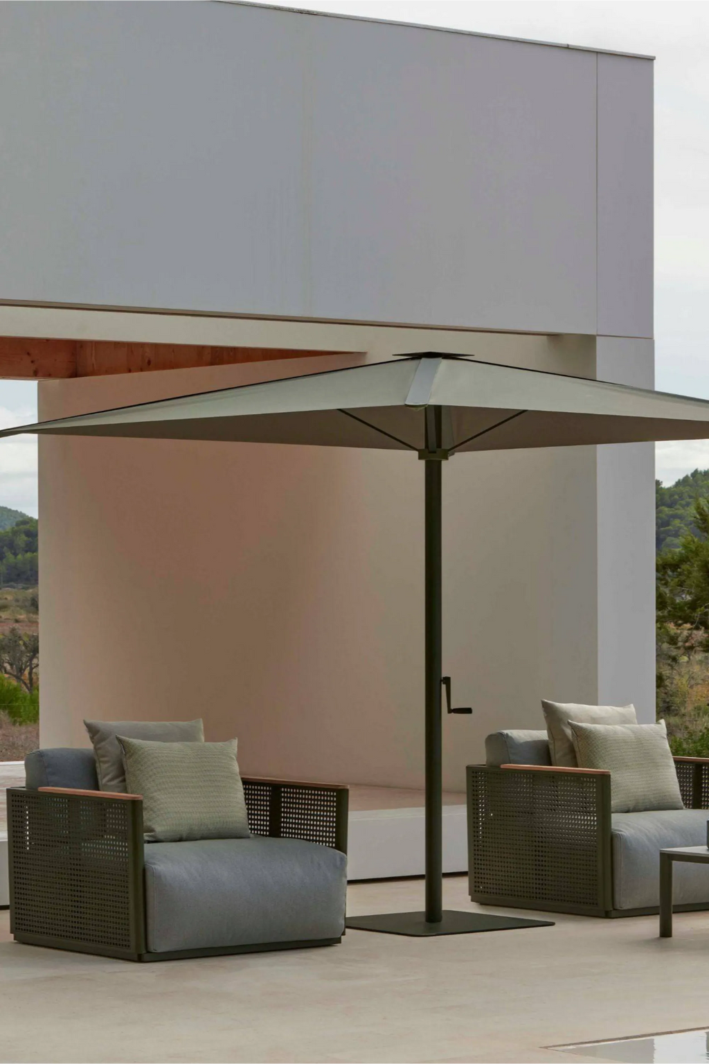 Gandia Blasco Bosc Armchair, a modern minimalist outdoor lounge chair featuring a dark olive green powder-coated aluminum frame with a distinctive perforated design and natural teak armrests.