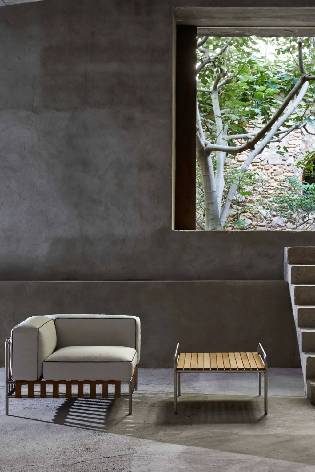 Gandia Blasco Onsen Sectional 6, a modern minimalist outdoor lounge chair module featuring a crisp off-white upholstered cushion with contrasting black piping, supported by a sleek brushed stainless steel frame and.
