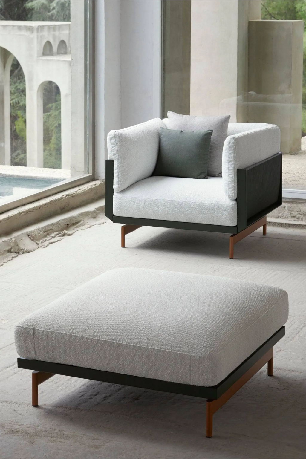 Gandia Blasco Onde Lounge Chair, a modern minimalist outdoor lounge chair featuring plush off-white bouclé outdoor fabric upholstery, a sleek matte black aluminum frame with textured ribbed side panels,.