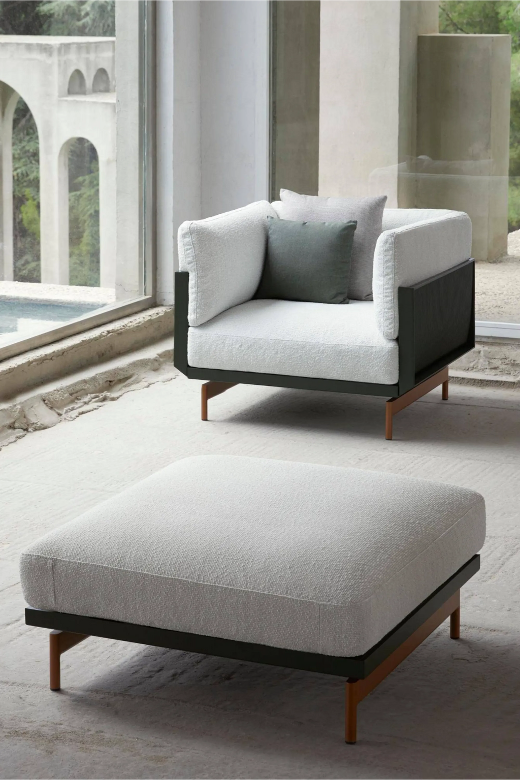Gandia Blasco Onde Sectional Pouf, a modern minimalist outdoor ottoman featuring light grey textured outdoor fabric upholstery and a sleek matte charcoal thermo-lacquered aluminum frame with warm natural teak wood legs. This contemporary outdoor pouf provides versatile seating or a stylish footrest for a patio, garden lounge, or modern outdoor living room.