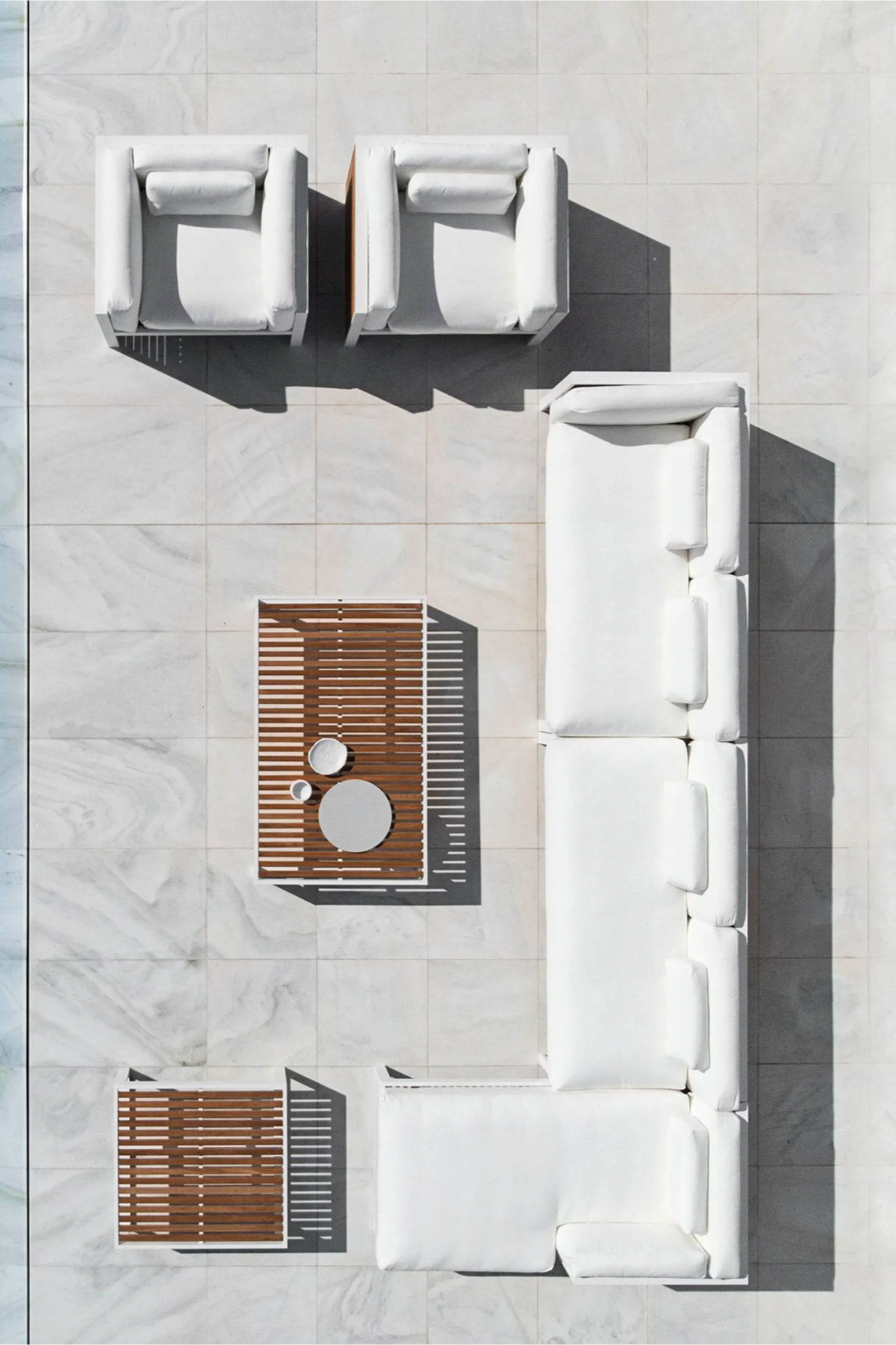 Gandia Blasco DNA Teak Sectional 1, a modern minimalist outdoor lounge set featuring a crisp white aluminum frame with natural teak wood slatted accents on the coffee table, side table, and armchair.