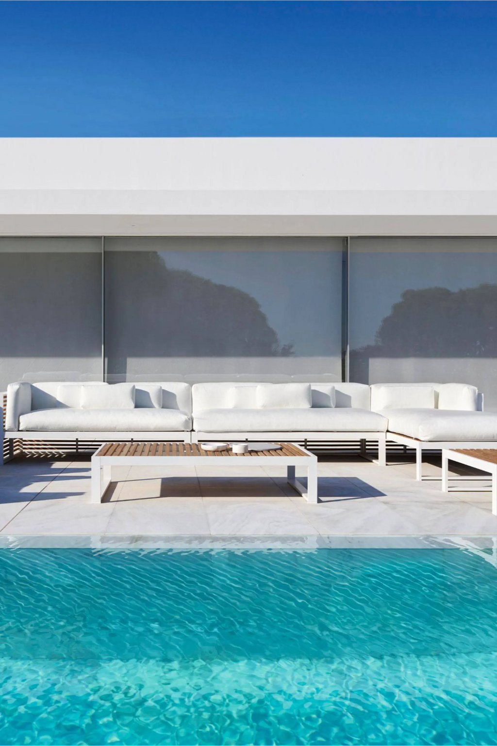 Gandia Blasco DNA Teak Sectional 4, a sleek modern minimalist outdoor sofa featuring a crisp white aluminum frame with natural teak wood slatted bases, complemented by plush white outdoor fabric.