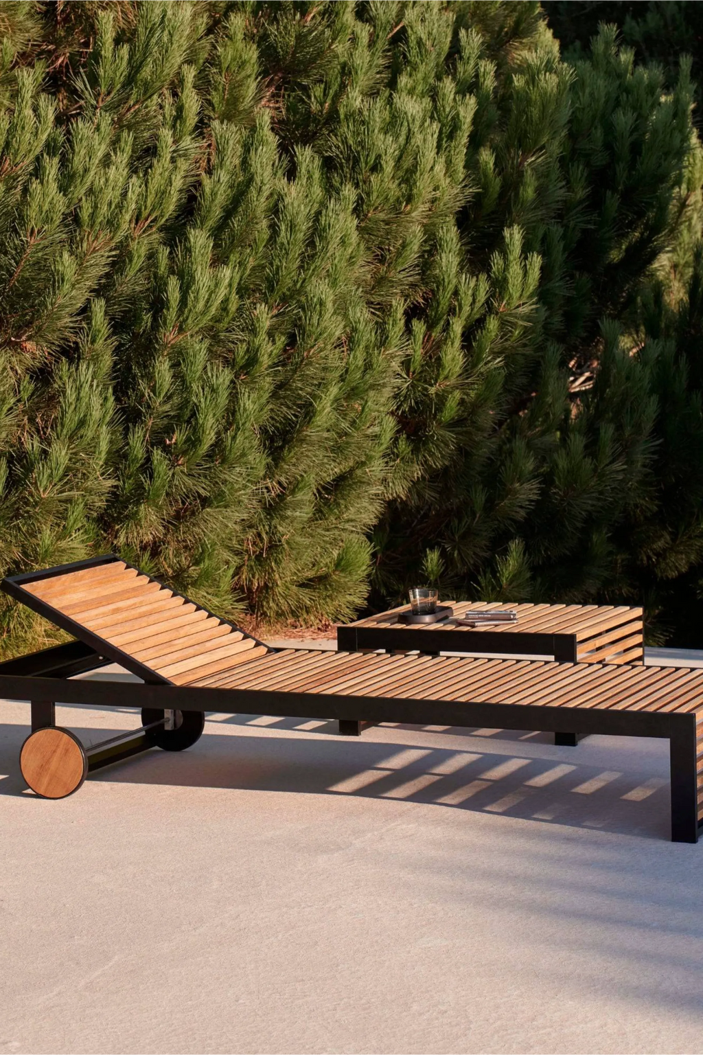 Gandia Blasco DNA Teak Side Table, a modern minimalist outdoor side table featuring a slatted natural teak wood top and a sturdy matte black metal frame. This contemporary rectangular outdoor end table is perfect for poolside, patio, or deck living spaces, offering a stylish solution for outdoor essentials.