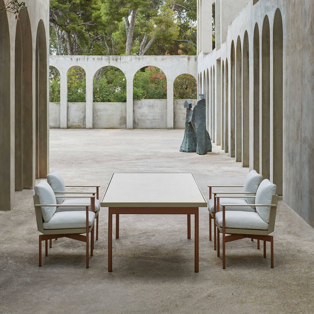 Gandia Blasco Onde Dining Table, a modern square outdoor dining table featuring a smooth light beige composite tabletop and sturdy reddish-brown powder-coated aluminum legs.