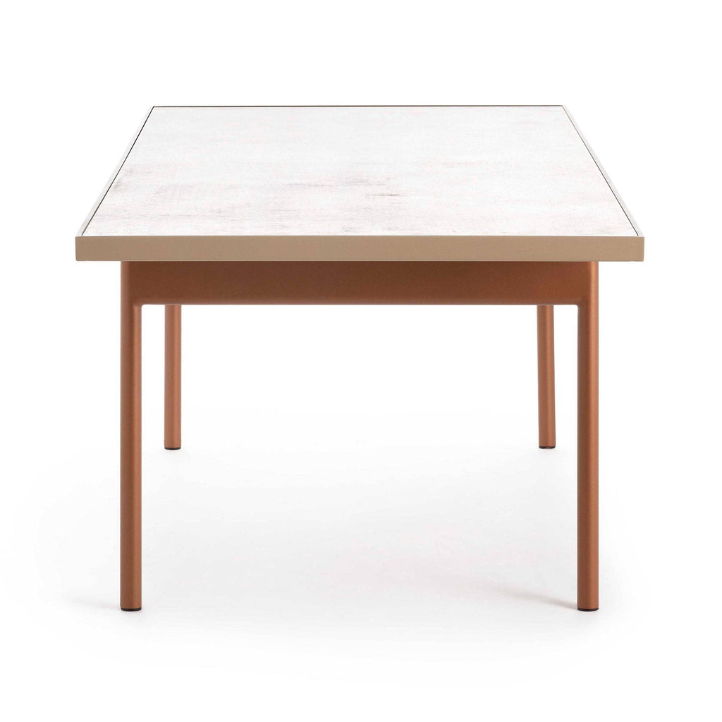 Gandia Blasco Onde Dining Table, a sleek rectangular outdoor dining table featuring a light grey textured tabletop and a sturdy matte copper-colored metal frame with minimalist straight legs. This contemporary outdoor table is crafted for modern patios and gardens, offering durable, clean lines for sophisticated al fresco dining.